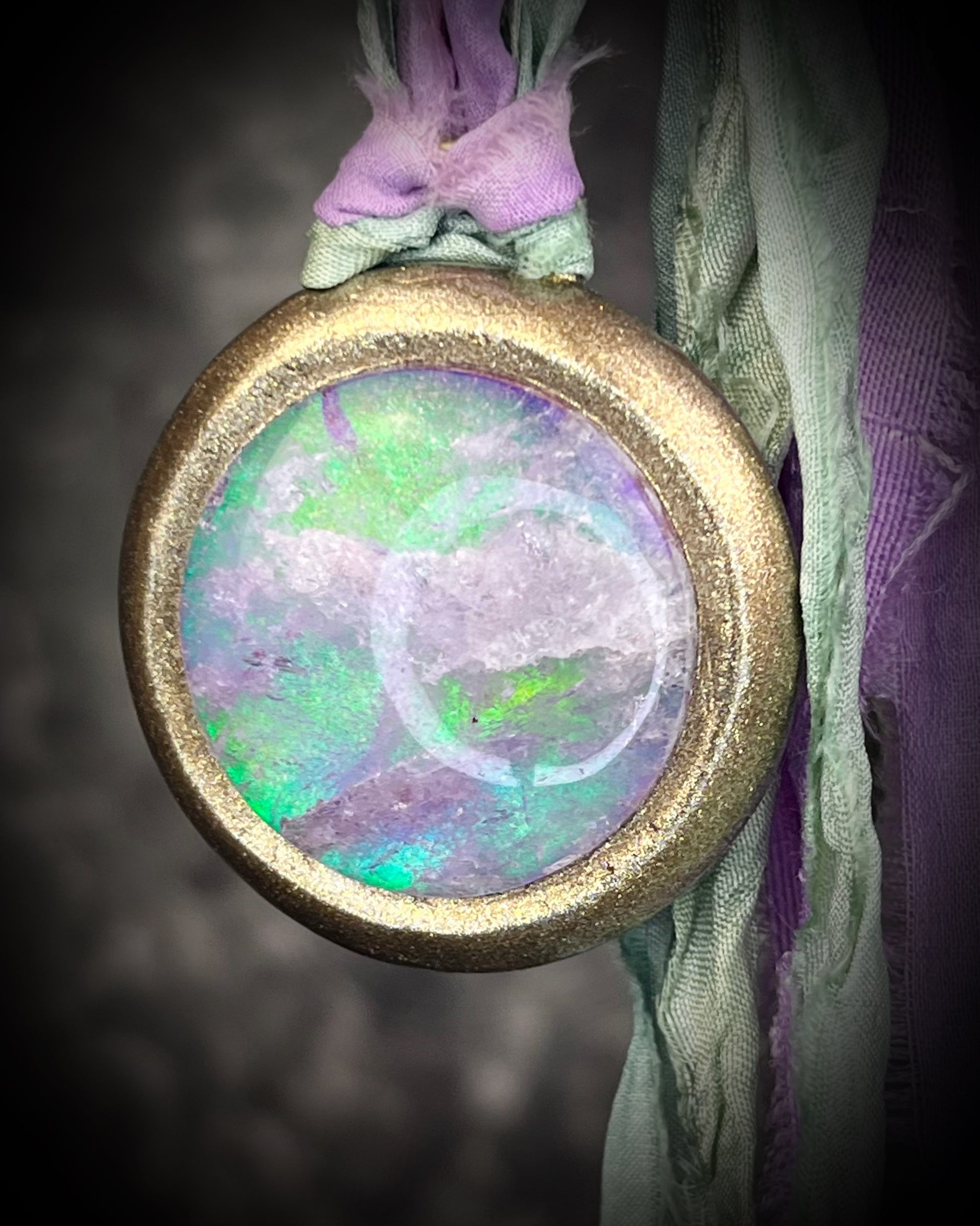 Quartz crystal doublet cosmic talisman with sculpted gold finish and lilac and sea green recycled silk ties, handmade by Become Spellbound. 
