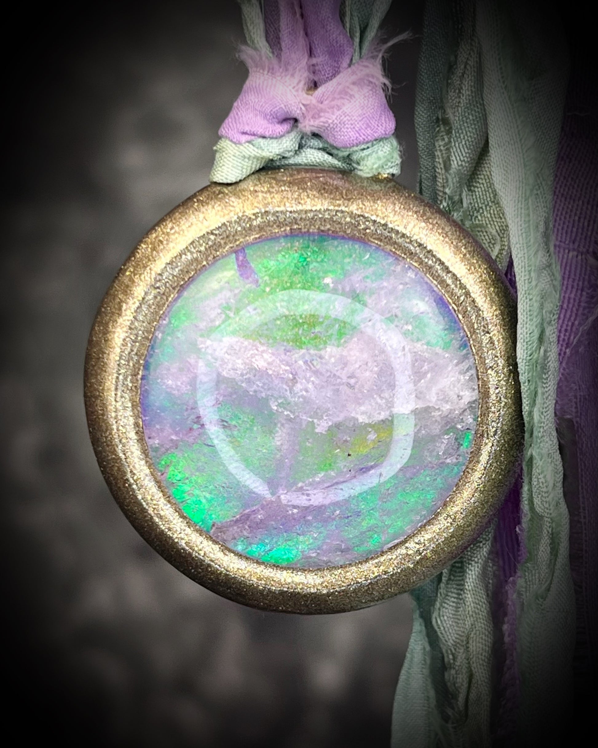 Quartz crystal doublet cosmic talisman with sculpted gold finish and lilac and sea green recycled silk ties, handmade by Become Spellbound. 