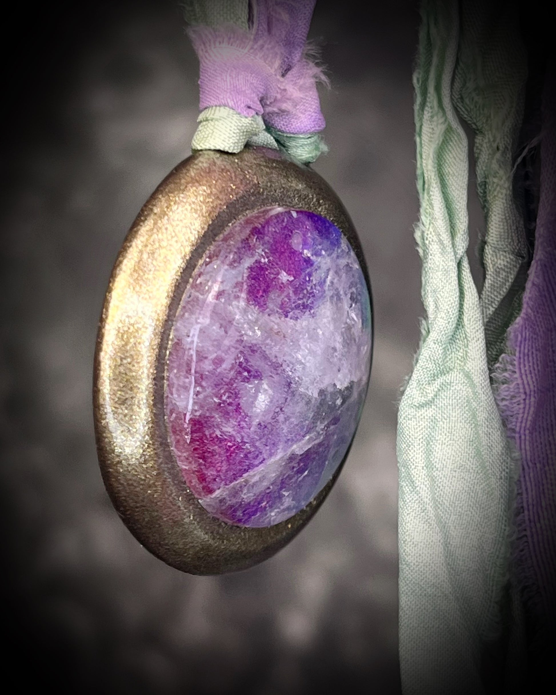 Quartz crystal doublet cosmic talisman with sculpted gold finish and lilac and sea green recycled silk ties, handmade by Become Spellbound. 