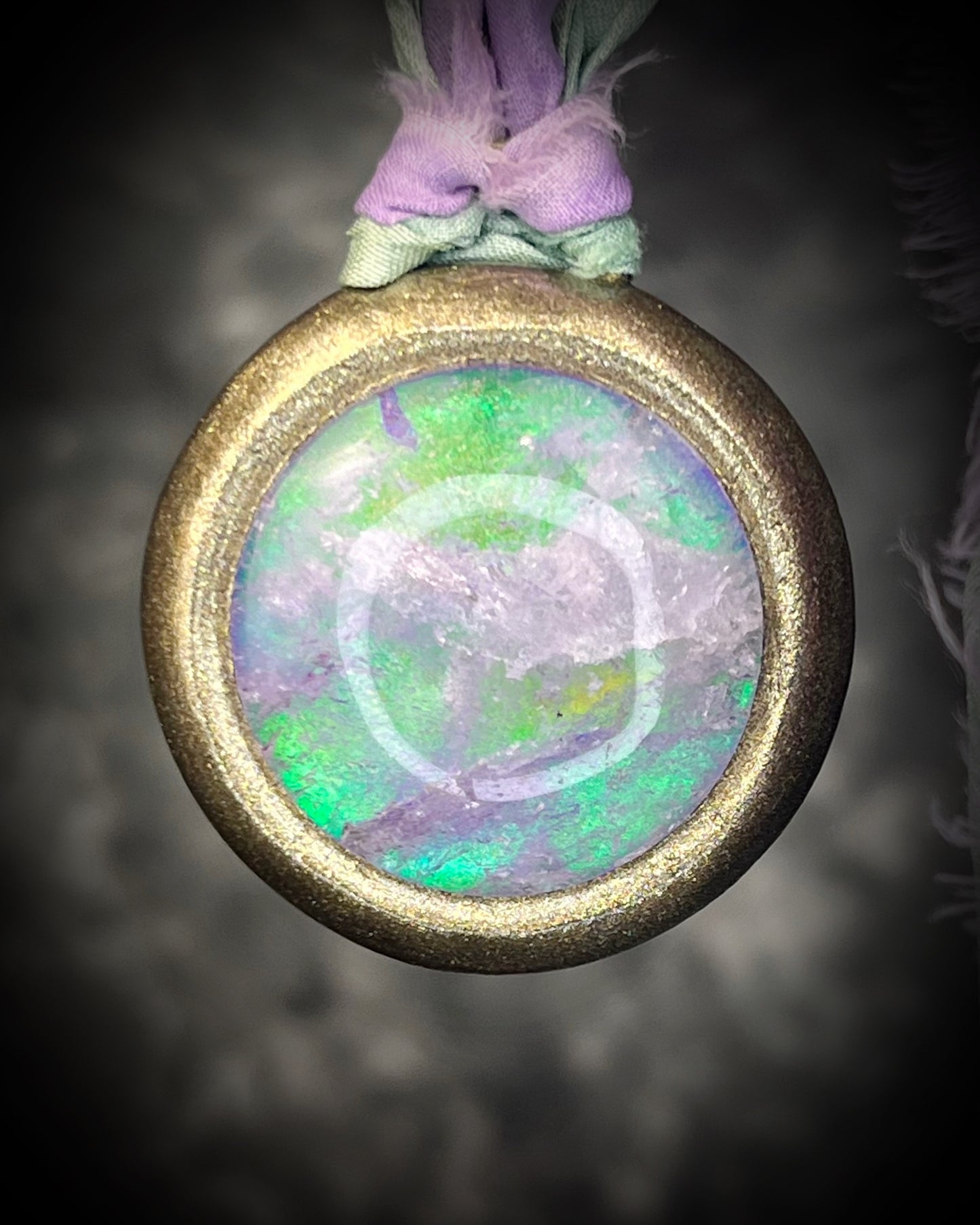 Quartz crystal doublet cosmic talisman with sculpted gold finish and lilac and sea green recycled silk ties, handmade by Become Spellbound. 