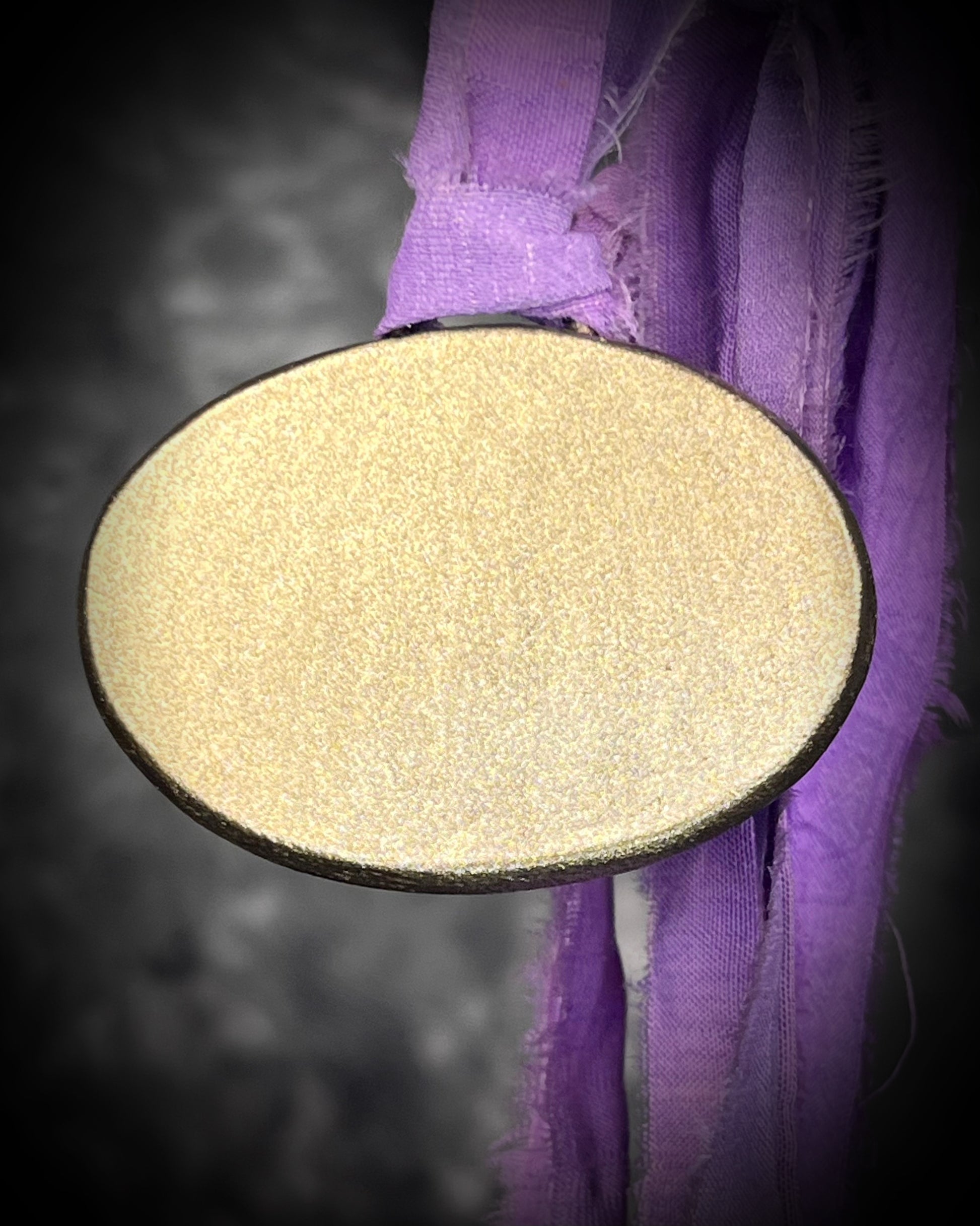 Rare purple flash labradorite talisman with sculpted gold finish and lilac recycled silk ties, handmade by Become Spellbound, Baltimore Magazine Best of Baltimore 2026 Jewelry winner.