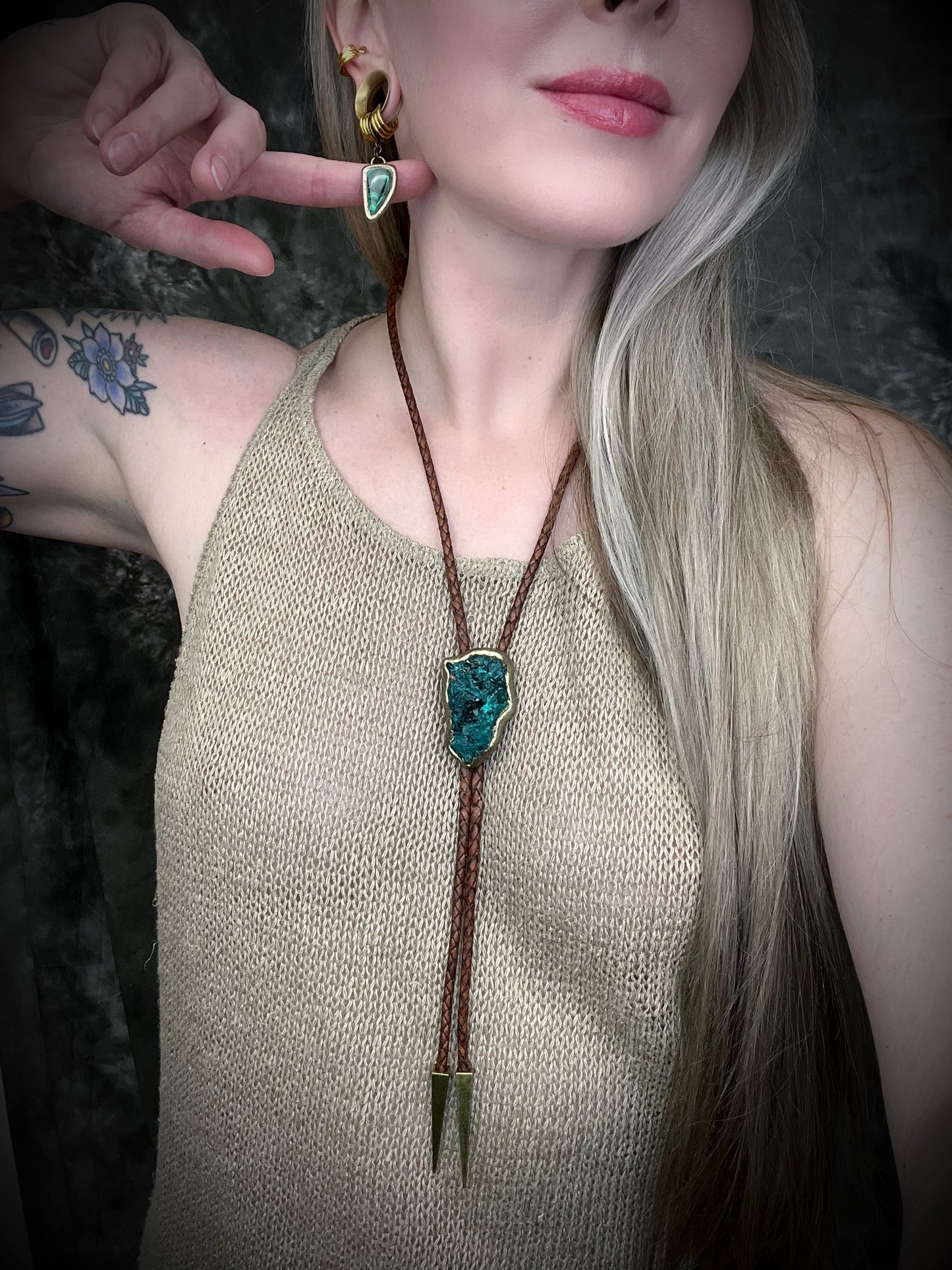 Raw Dioptase teal colored gemstone Bolo tie set in a gold finish and mounted on earthy brown leather. A talisman for heart chakra healing, crystal jewelry for him. Western 2026 jewelry trend bolo. 