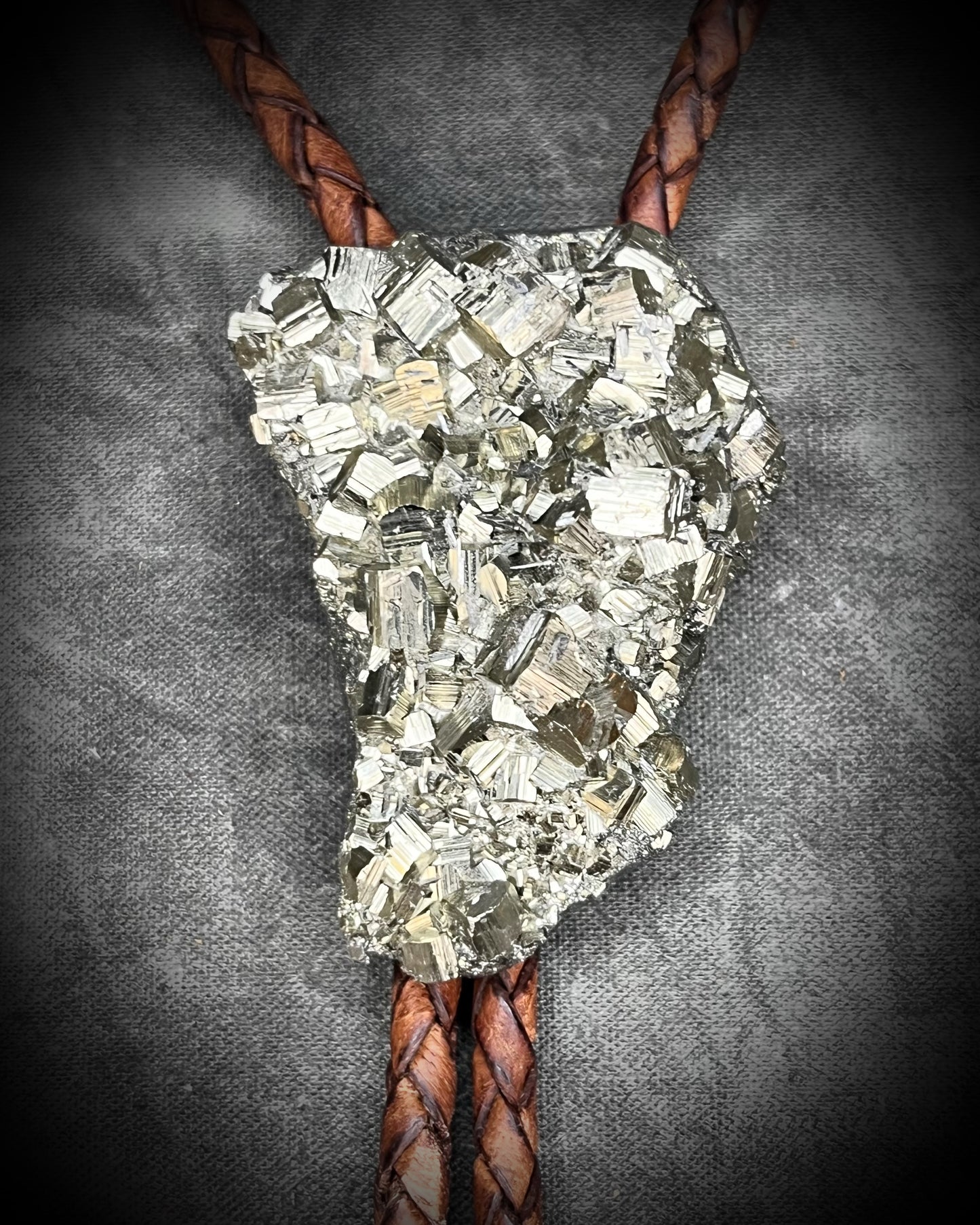 Raw Pyrite gemstone Bolo tie set in an invisible finish and mounted on earthy brown leather. A talisman for ambition, success, and manifestation for the holidays and new year. Perfect gift for him!