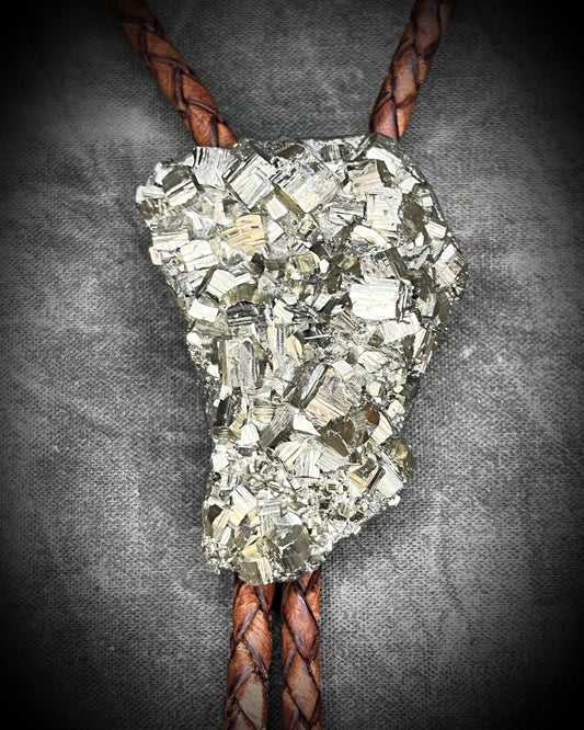 Raw Pyrite gemstone Bolo tie set in an invisible finish and mounted on earthy brown leather. A talisman for ambition, success, and manifestation for the holidays and new year. Perfect gift for him!