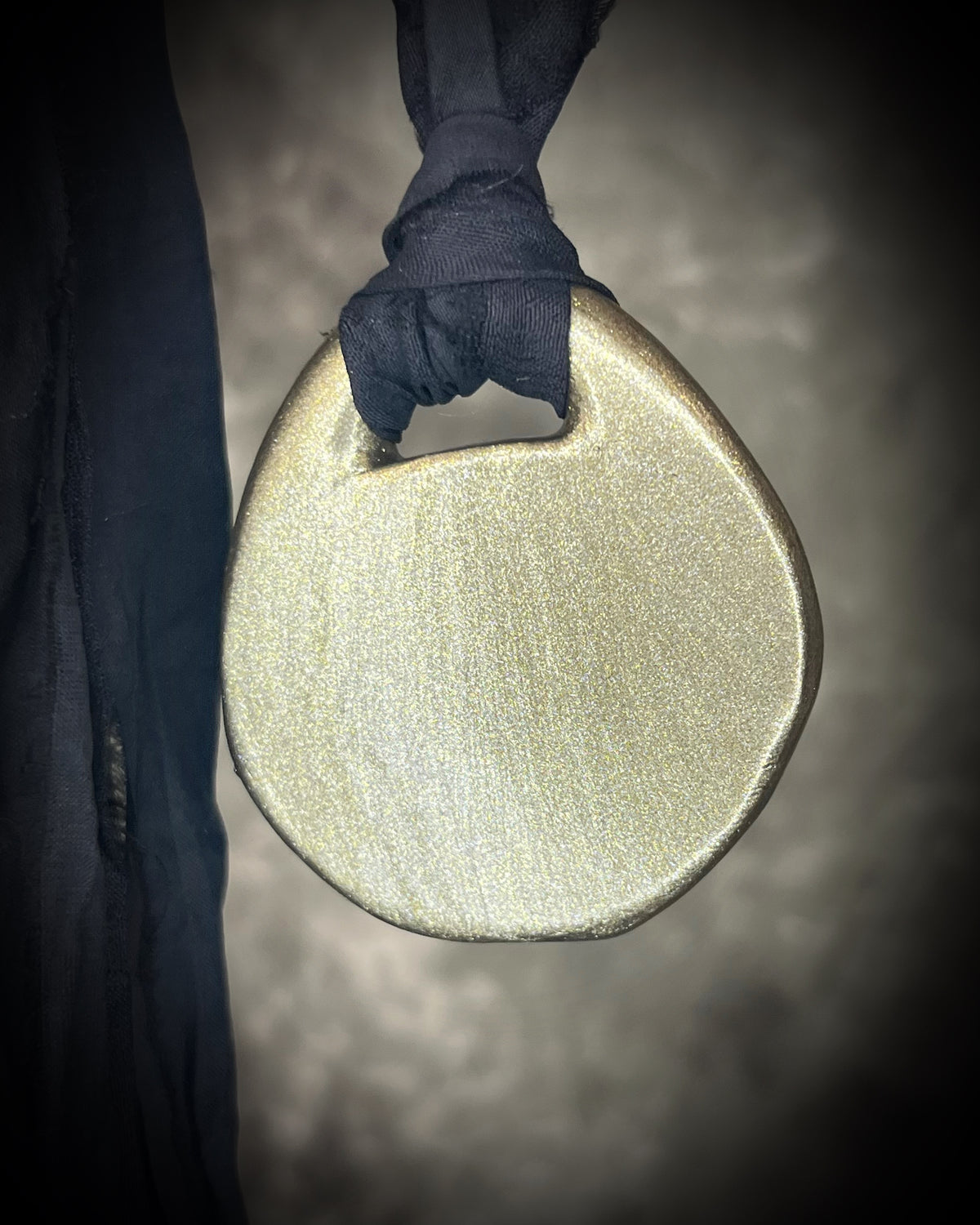 Raw black tourmaline chunk protection talisman with gold finish on black recycled silk, handmade by Become Spellbound in Baltimore, Maryland. 