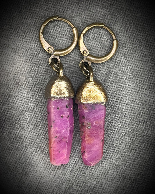 Raw ruby crystal earrings in gold finish on hypoallergenic brass huggie hooks, July birthstone gemstone jewelry handmade in Baltimore Maryland. Closeup.