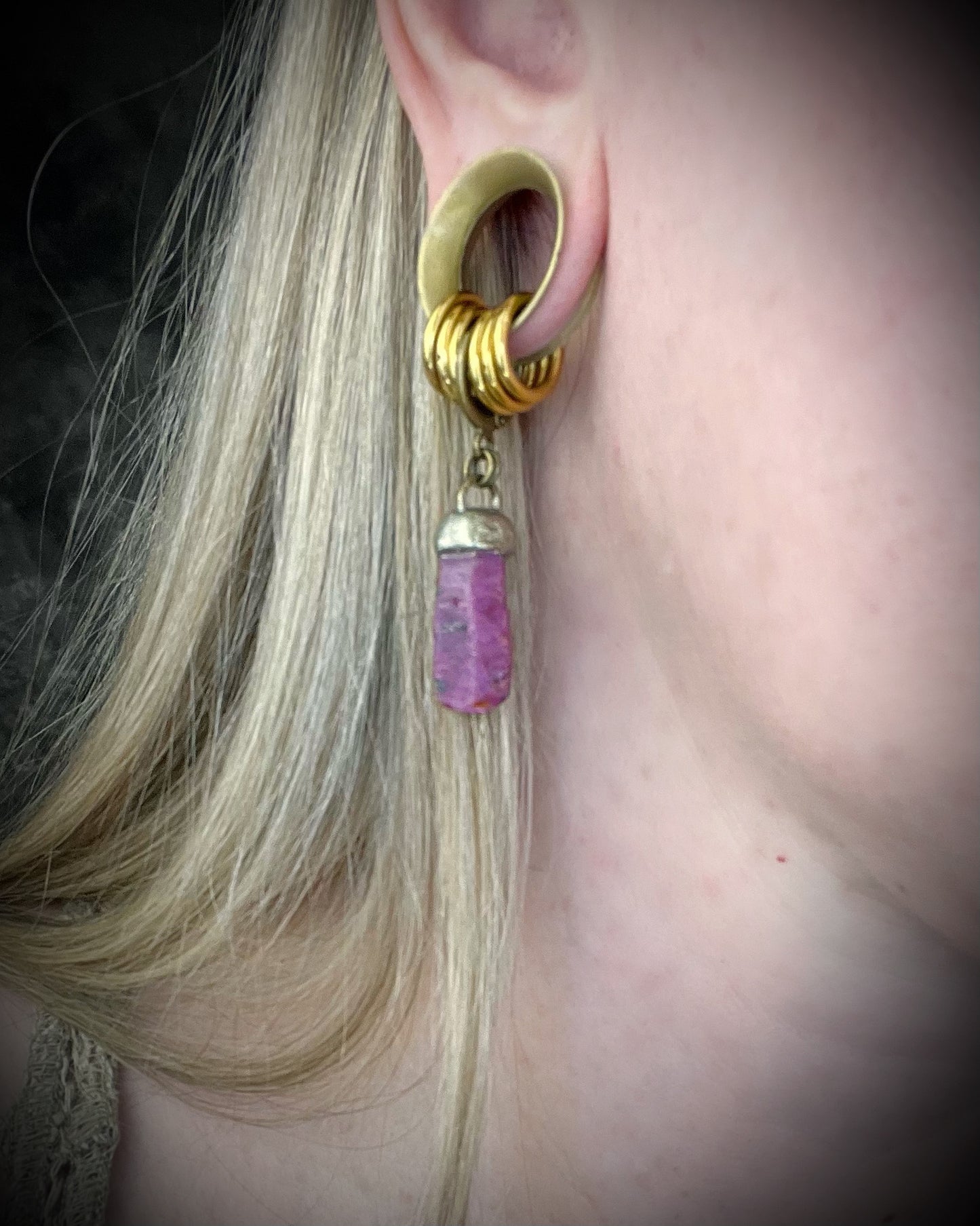 Raw ruby crystal earrings in gold finish on hypoallergenic brass huggie hooks, July birthstone gemstone jewelry handmade in Baltimore Maryland. Worn here.