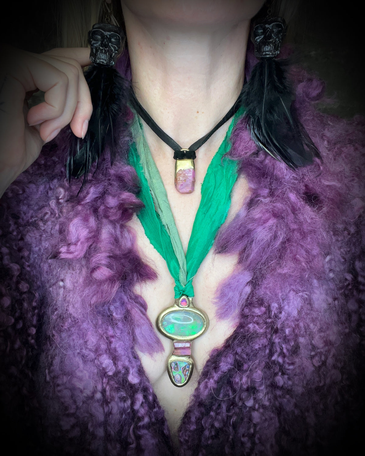 Raw ruby crystal talisman with natural texture in a sculptural gold-finish setting on black leather, handmade by Become Spellbound in Baltimore, Maryland.