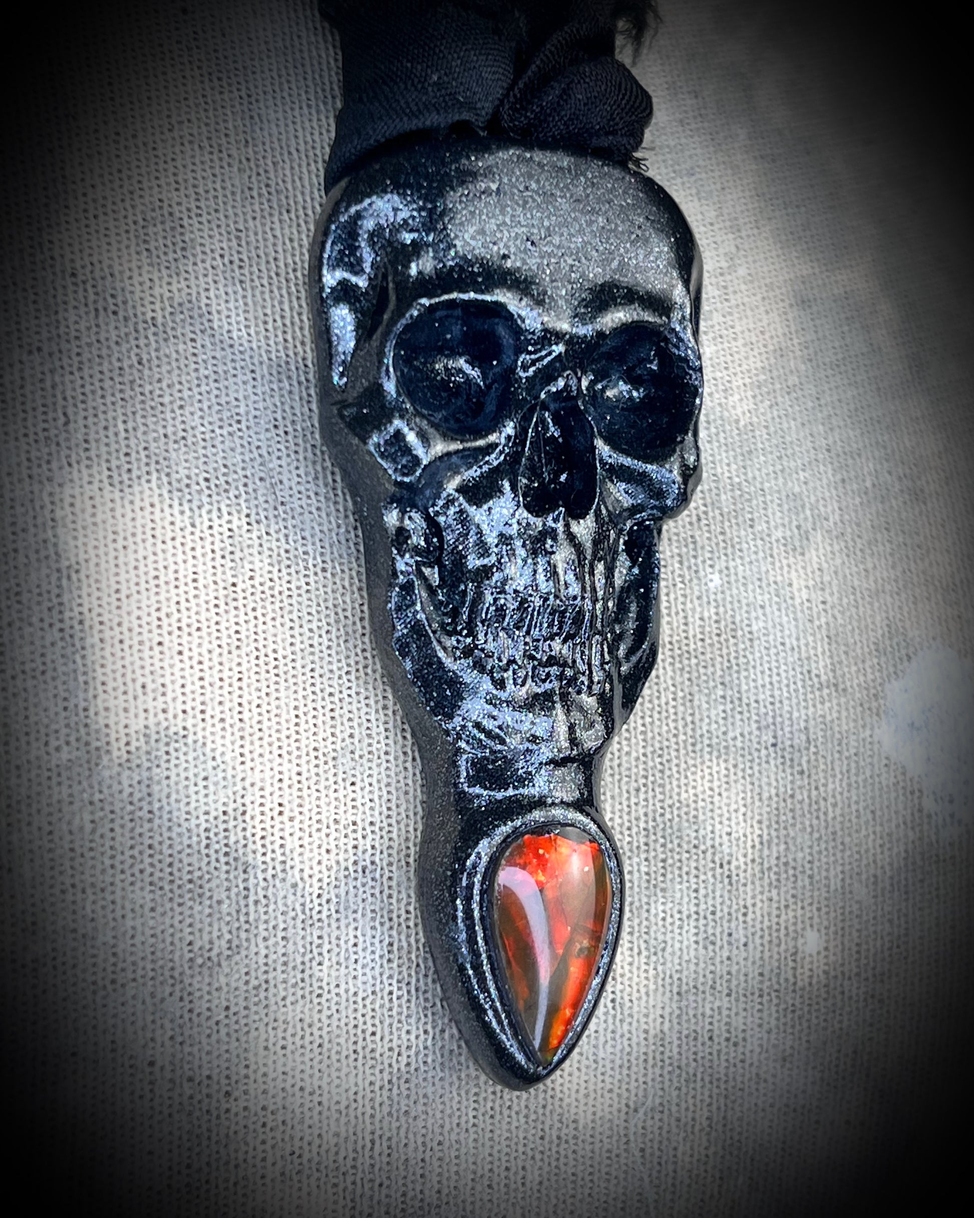 Black skull and red opalized ammolite gem necklace on black recycled silk.  Macabre gothic jewelry for her, halloween gemstone jewelry for fall 2025 gift for him.