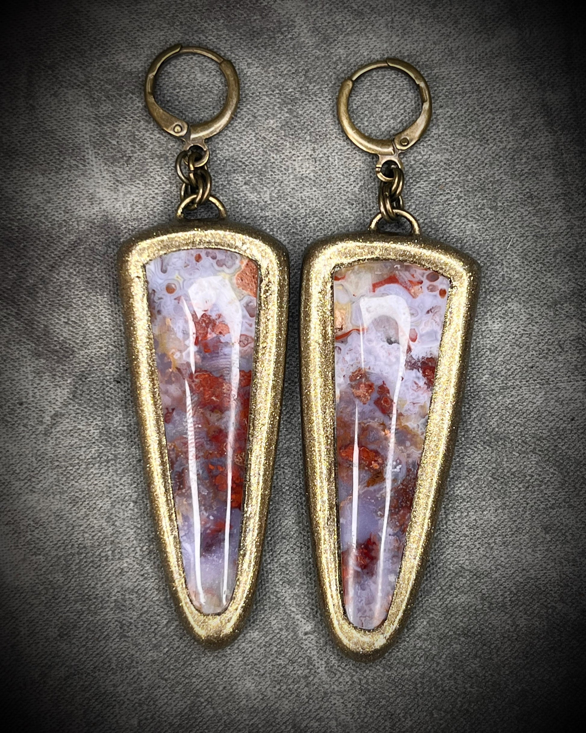 Red moss agate earrings in rich red and lilac colors with hypoallergenic brass huggie hooks in a gold tone, statement gemstone jewelry handmade in Baltimore Maryland. 