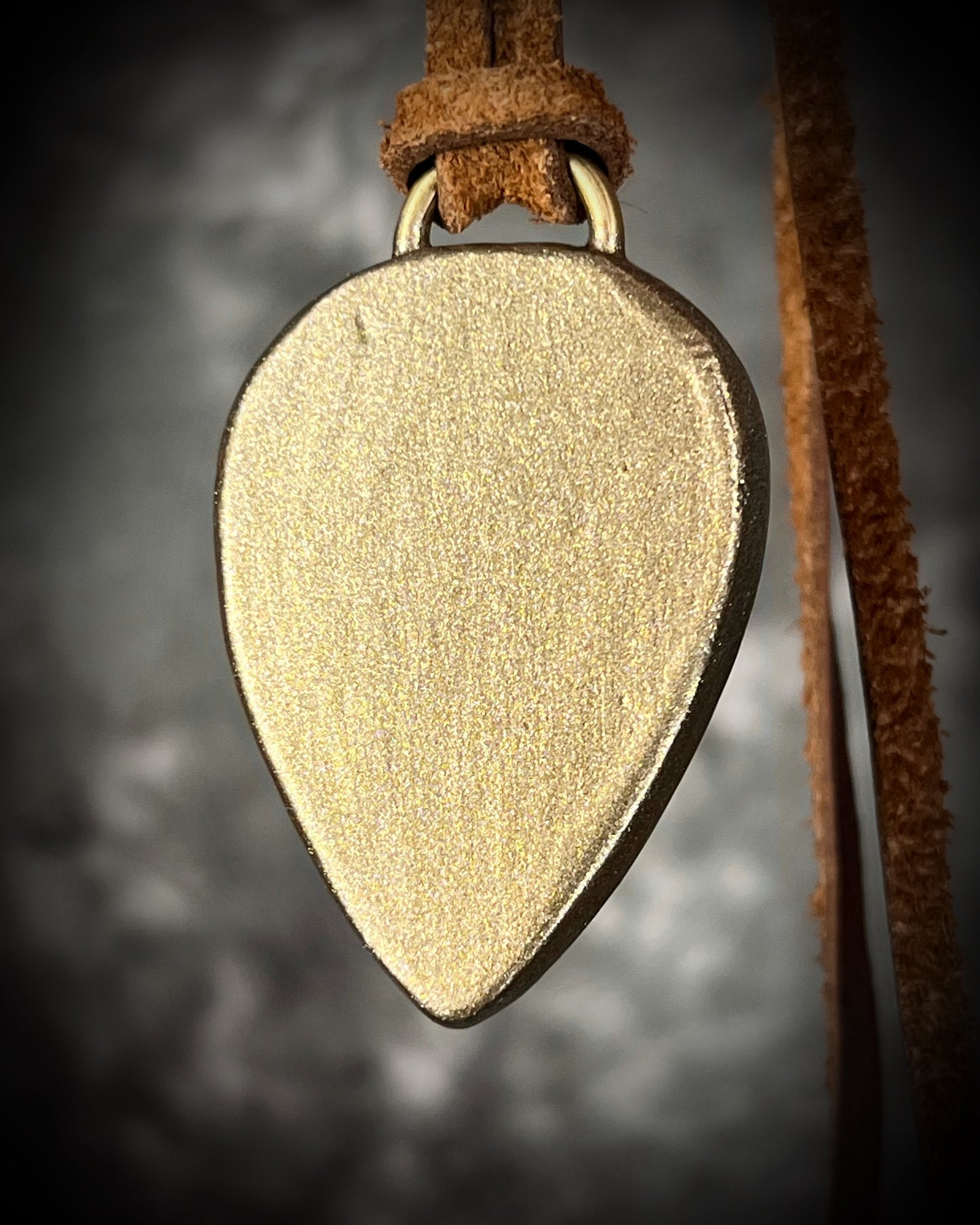 Red moss agate pendant in a gold finish, handmade and hung from brown earthy leather. Empowering and manifestation talisman for 2026 year of the fire horse. Back view. 