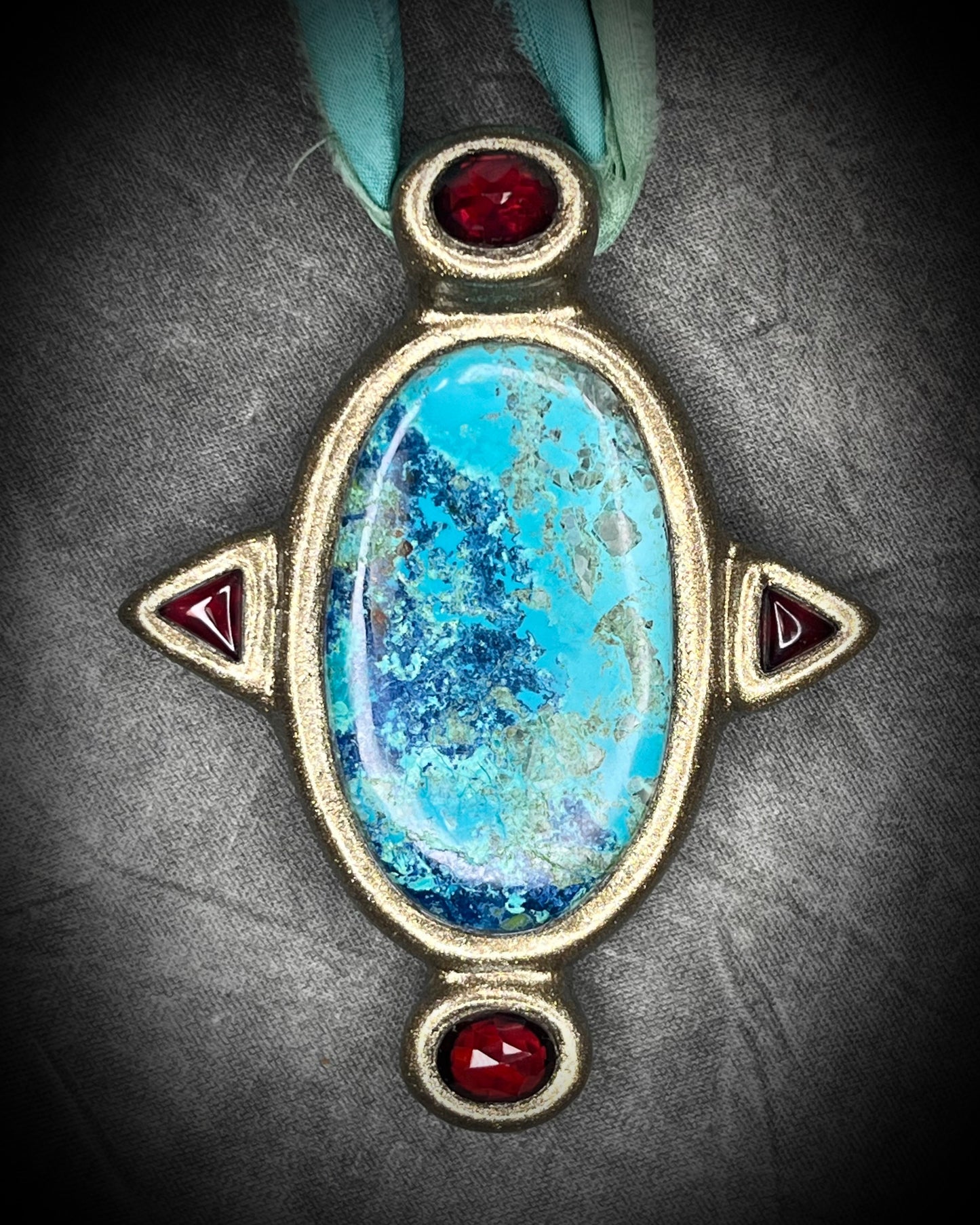 Regal handmade chrysocolla pendant adorned with 4 sparkling garnets in the cardinal directions. The Empress Talisman, gold finish artisanal pendant on soft aqua recycled silk. Statement jewelry for her. 