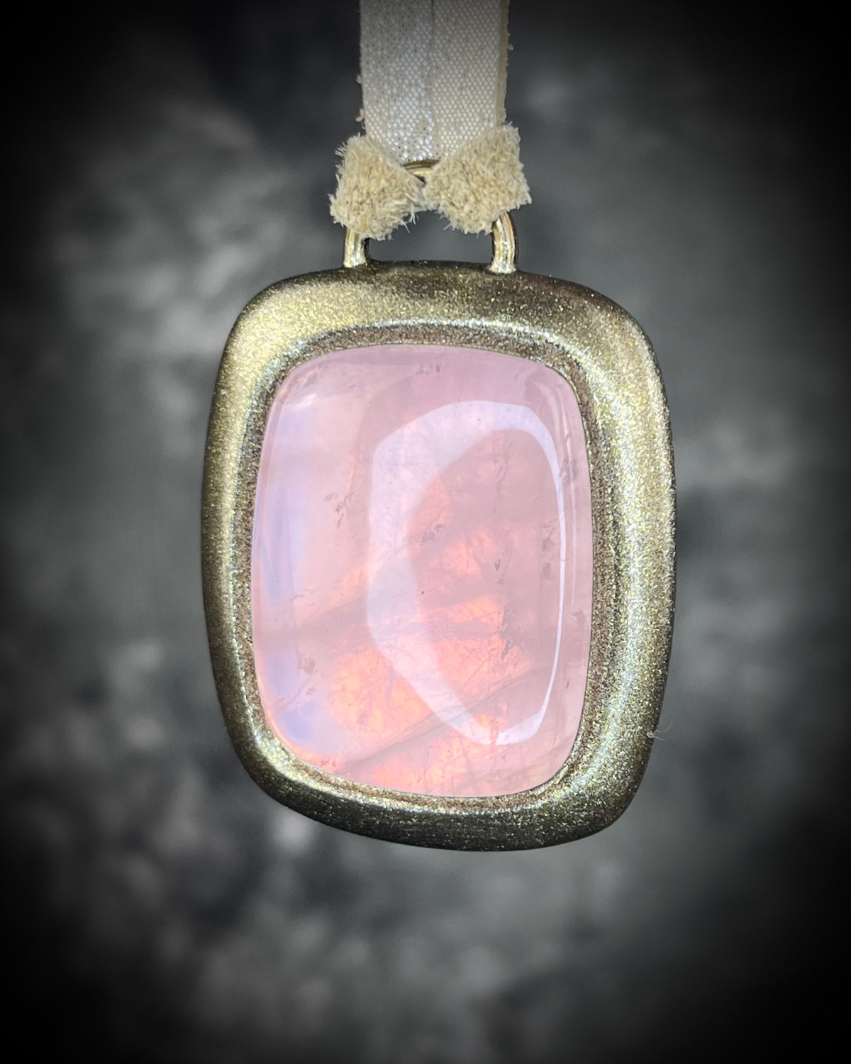 Rose quartz handmade necklace in gold finish on gold shimmering leather. Artisan jewelry made by Baltimore's Best Jeweler  2026 winner Become Spellbound. 