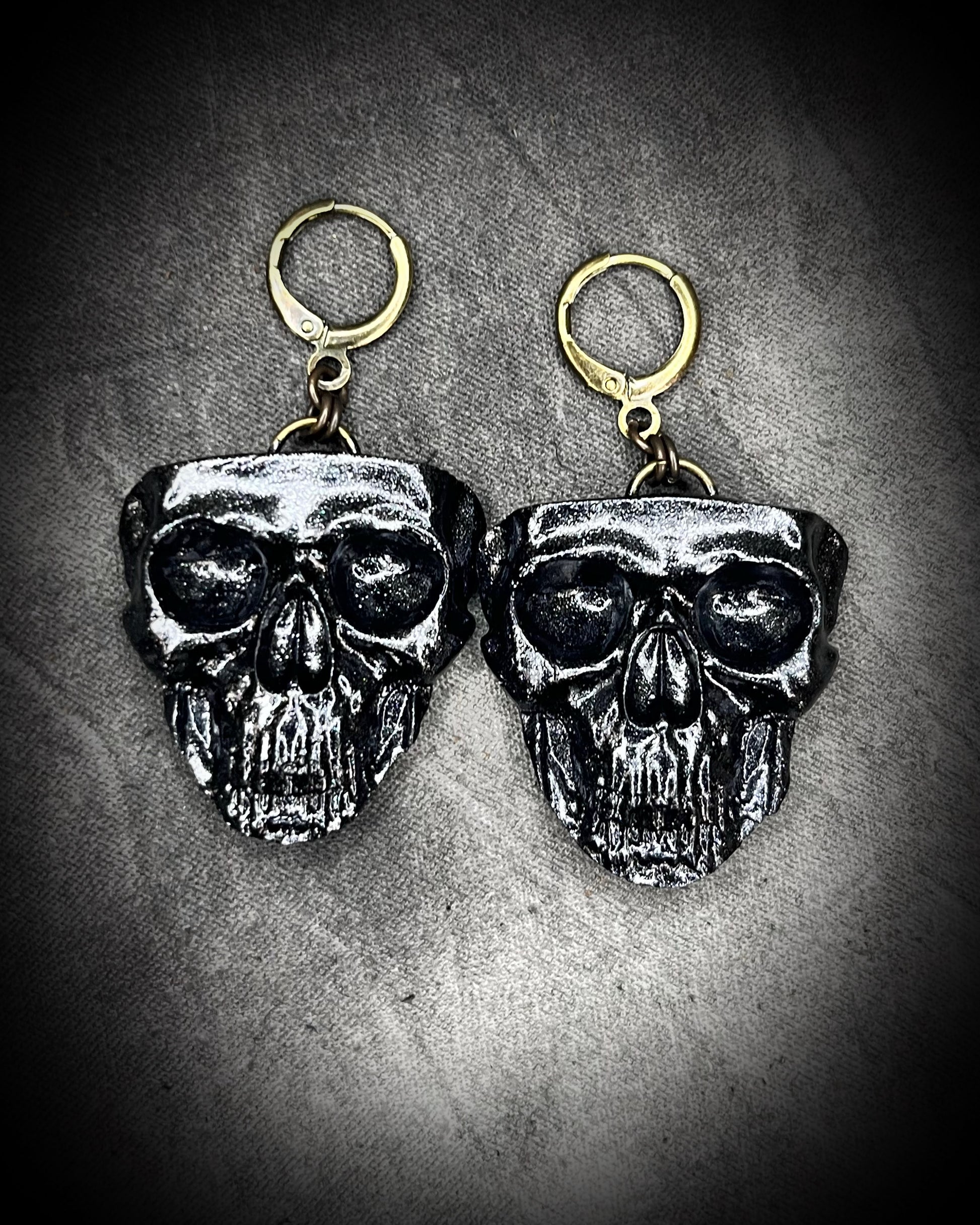 Sculptural black skull earrings on hypoallergenic brass hooks — gothic handmade statement earrings.