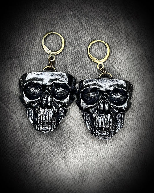 Sculptural black skull earrings on hypoallergenic brass hooks — gothic handmade statement earrings.