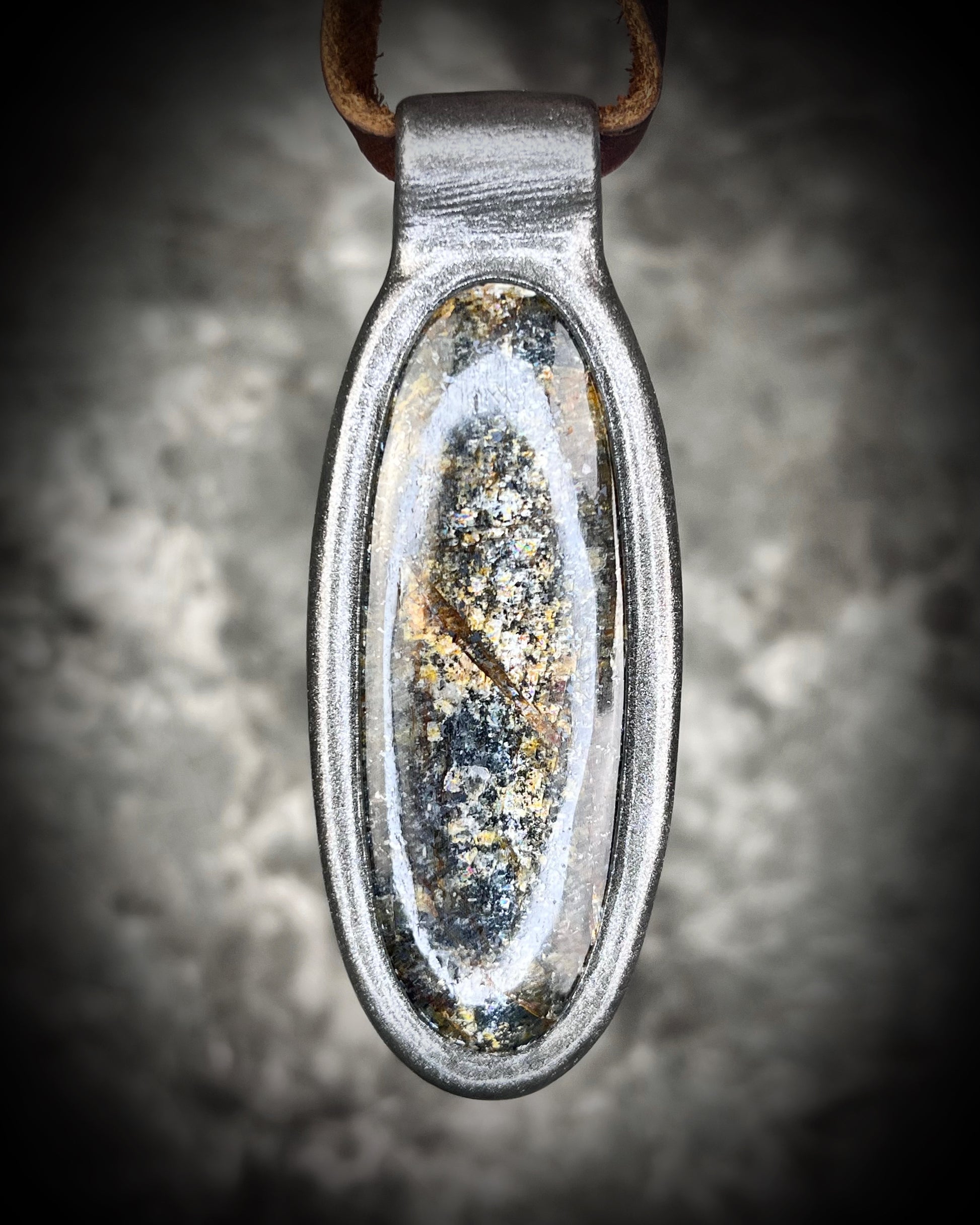 Shimmering moss kyanite crystal healing talisman in dark silver finish hung from soft and rugged brown leather. Gift intuition, transformation and communication.
