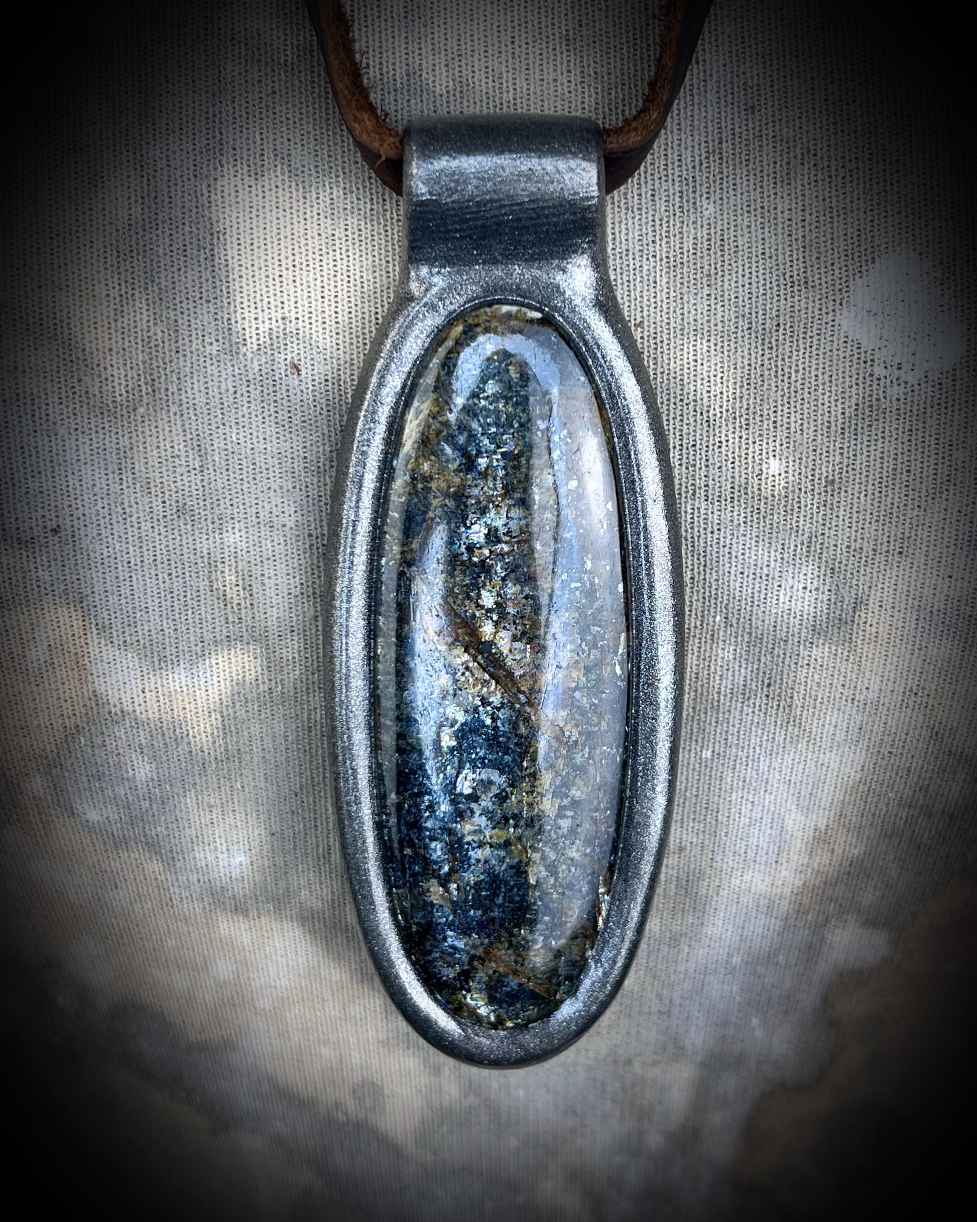 Shimmering moss kyanite crystal healing talisman in dark silver finish hung from soft and rugged brown leather. Gift intuition, transformation and communication.