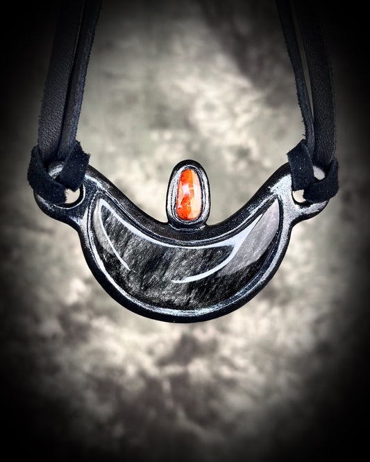 Silver Sheen obsidian crescent moon necklace with orange kyanite crystal.  Dark luxury vibe gemstone necklace hung from black leather for a unisex goth look.  