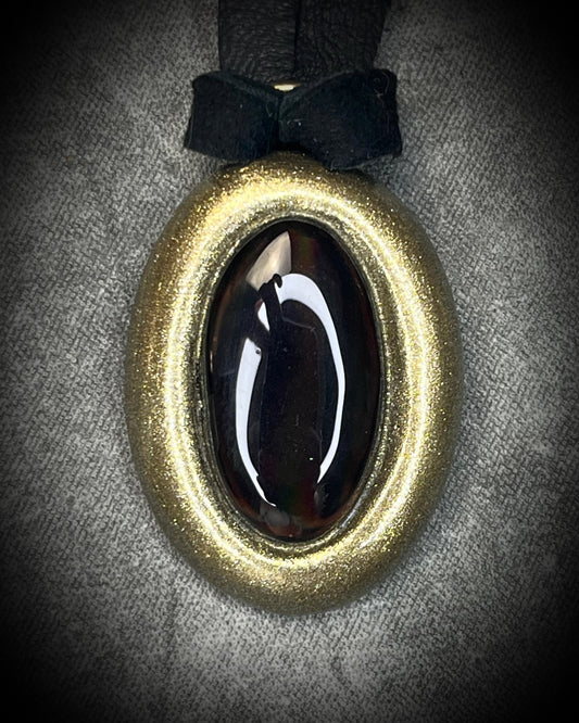 Smoky quartz protection talisman with natural translucent brown crystal, gold finish, and black leather, handmade by Become Spellbound in Baltimore, Maryland.