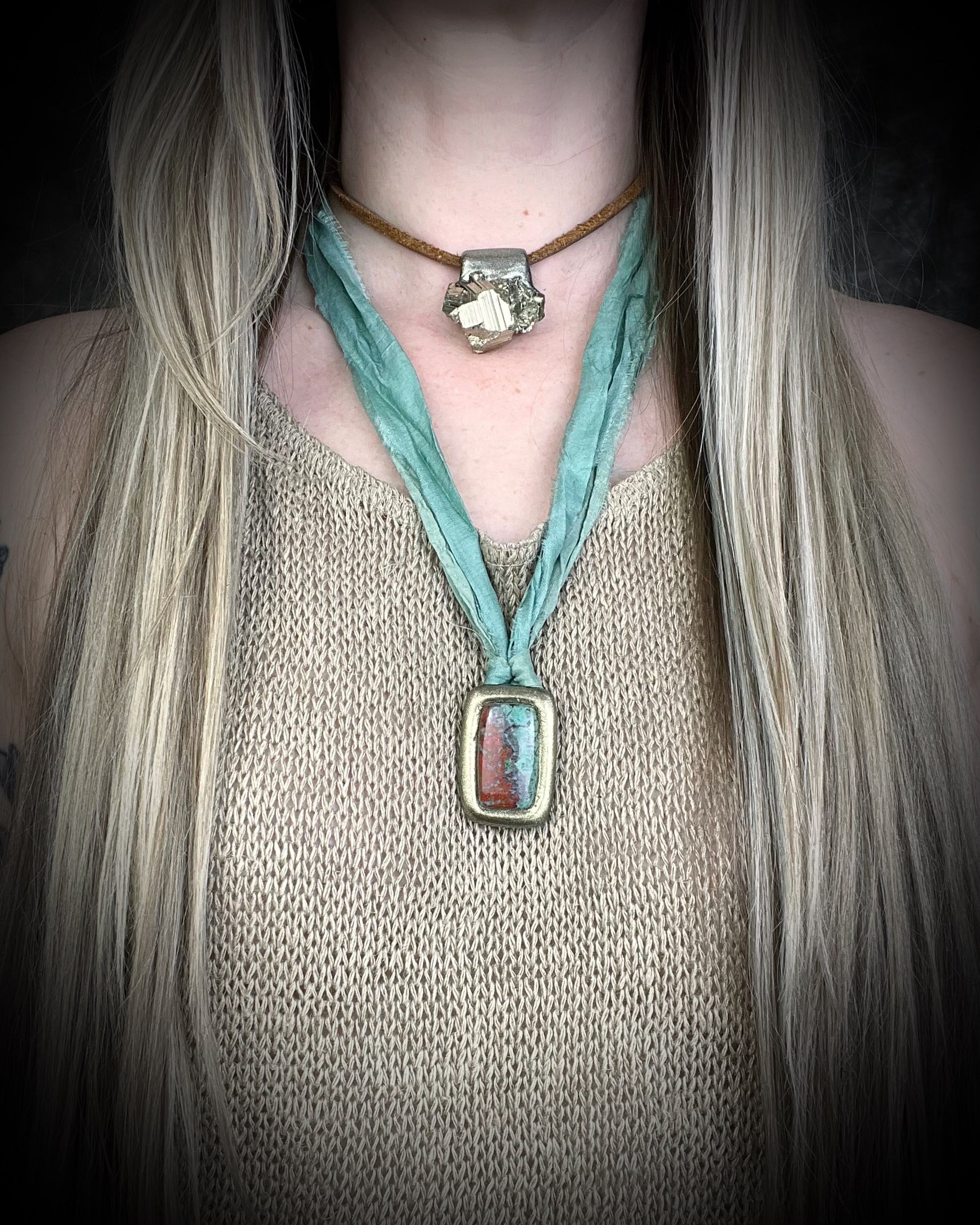 Sonora Sunrise gemstone Necklace with a large square pendant on recycled silk on a person wearing a beige top. Boho western 2026 jewelry trend talisman for her. 