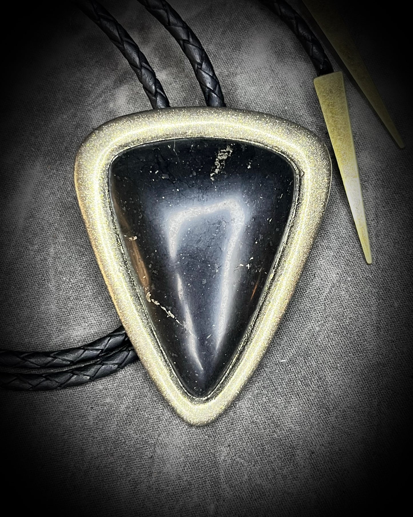 Statement bolo tie styled on neutral linen display