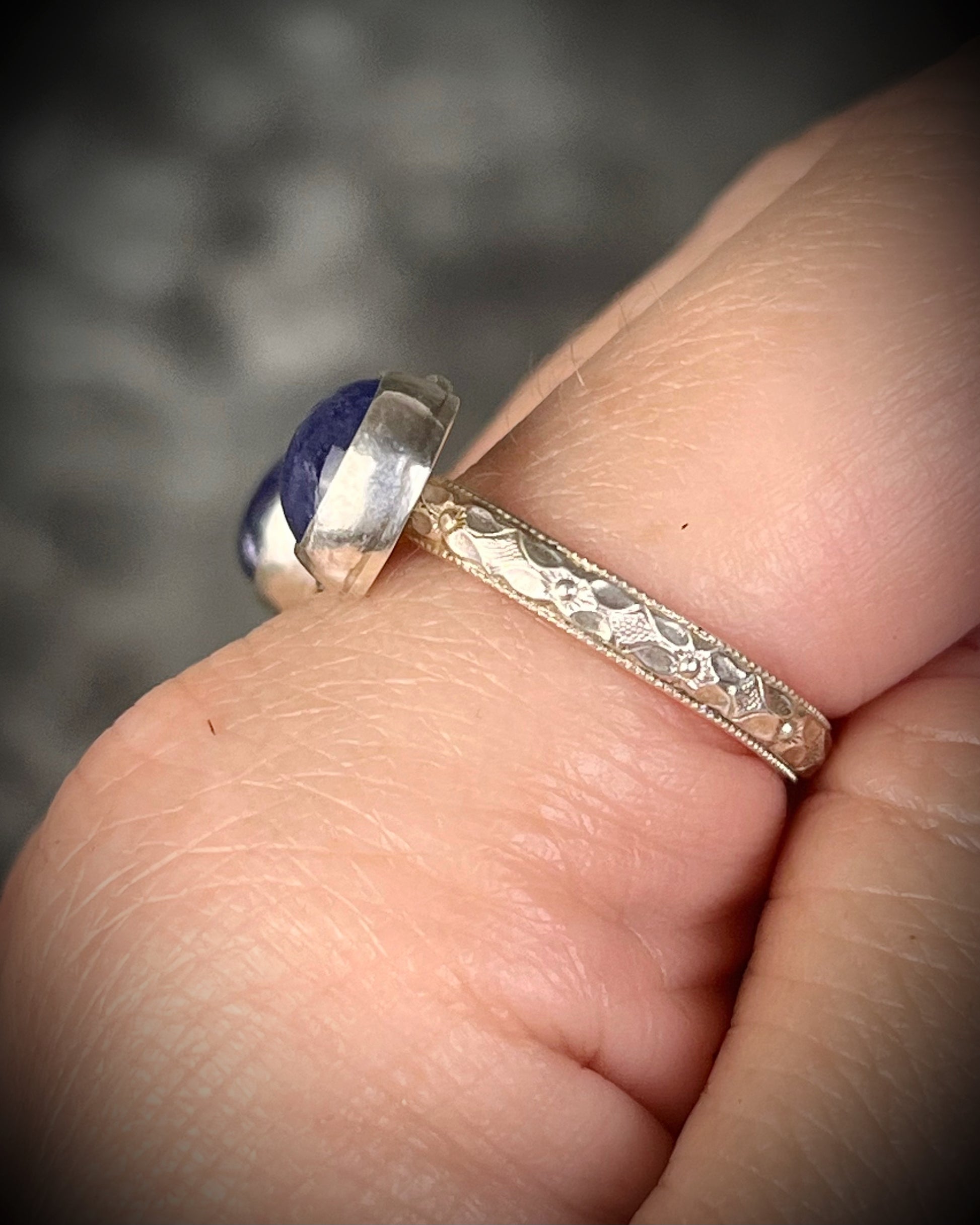 Tanzanite sterling silver moon ring with slightly adjustable band, celestial gemstone jewelry with violet blue stone for intuition and spiritual connection. Side view, band texture. 