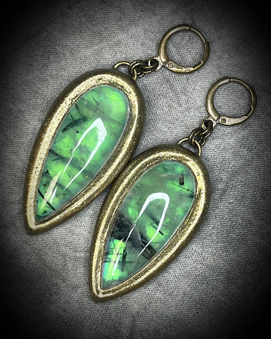 Teardrop-shaped prehnite crystal earrings with soft green color, gold finish, and hypoallergenic earring hooks, handmade by Become Spellbound.