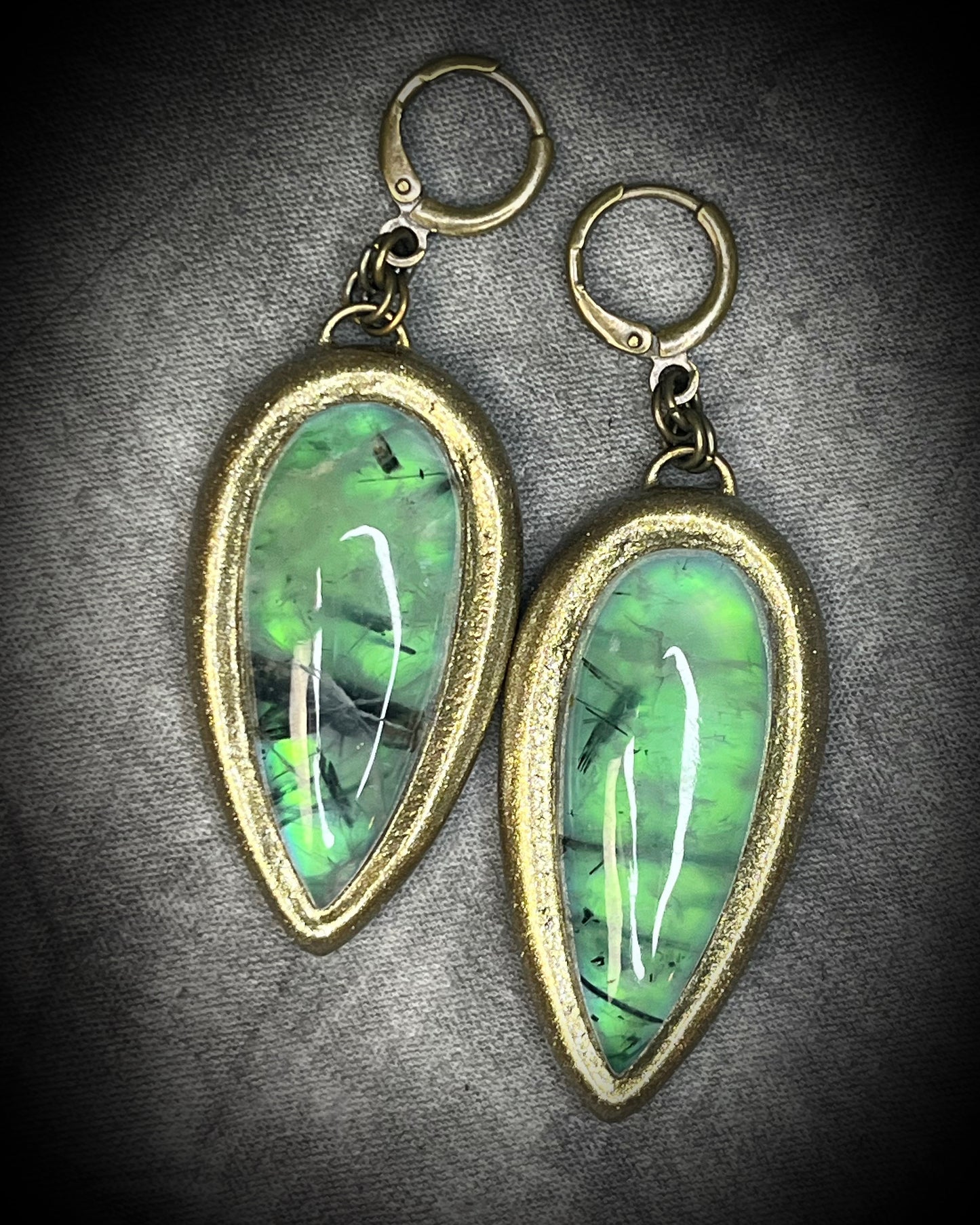 Teardrop-shaped prehnite crystal earrings with soft green color, gold finish, and hypoallergenic earring hooks, handmade by Become Spellbound.