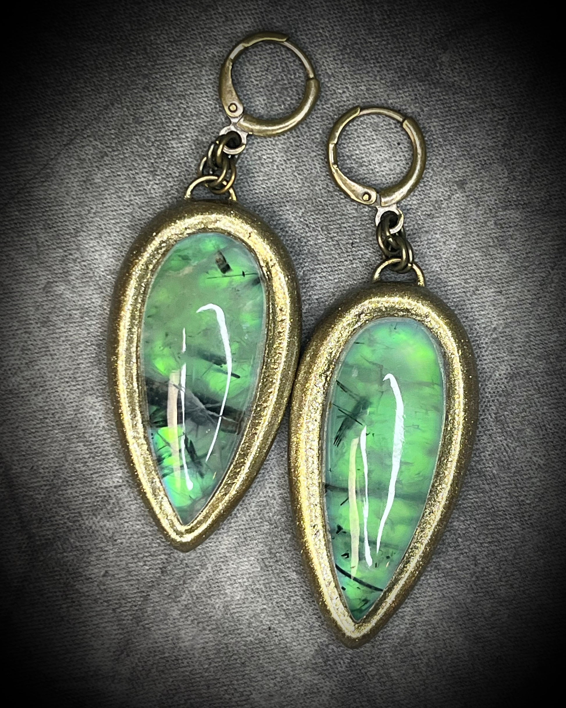 Teardrop-shaped prehnite crystal earrings with soft green color, gold finish, and hypoallergenic earring hooks, handmade by Become Spellbound.