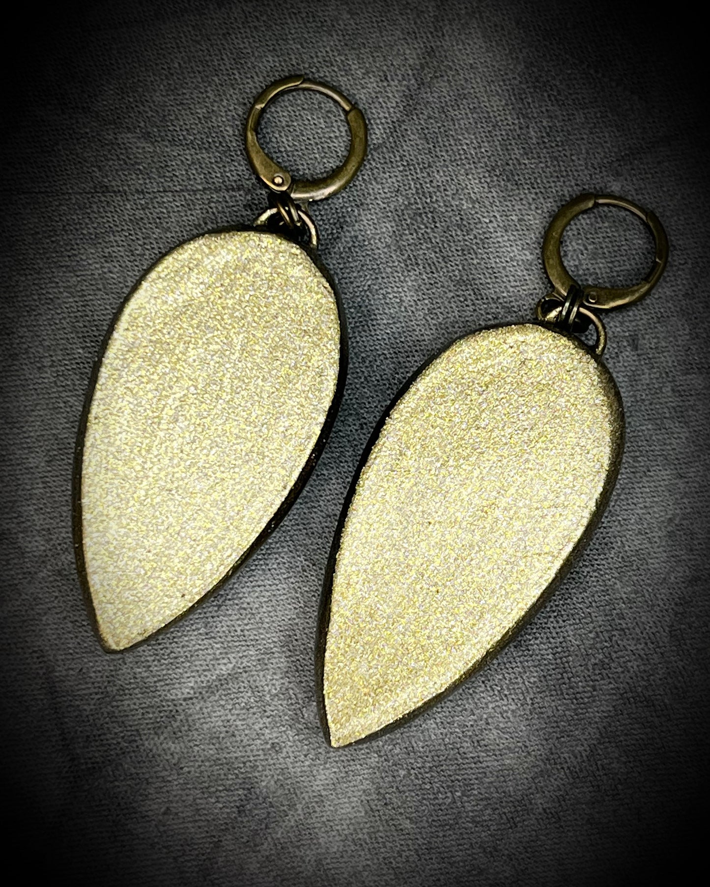 Teardrop-shaped prehnite crystal earrings with soft green color, gold finish, and hypoallergenic earring hooks, handmade by Become Spellbound.