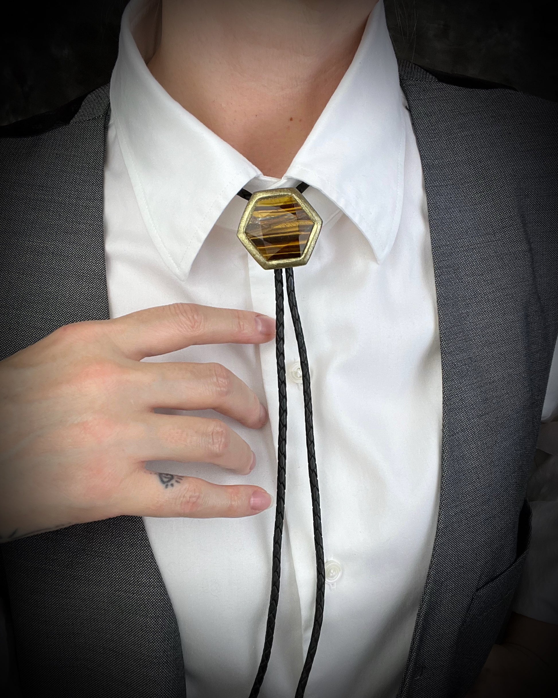 Tiger’s Eye hexagon bolo tie on black leather – statement men’s bolo necklace, crystal bolo tie jewelry, mystical Western bolo for festival fashion.