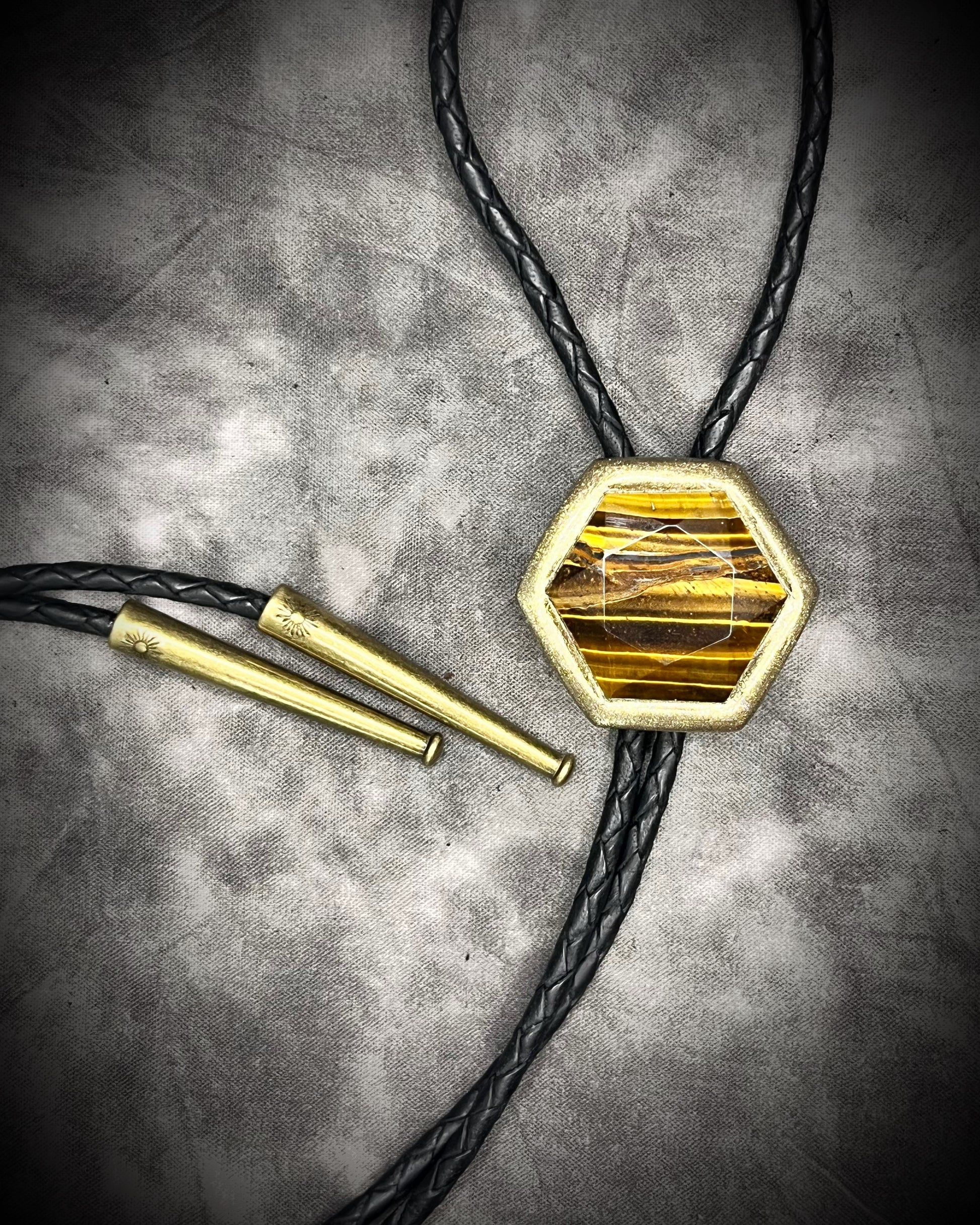 Tiger’s Eye hexagon bolo tie on black leather – statement men’s bolo necklace, crystal bolo tie jewelry, mystical Western bolo for festival fashion.