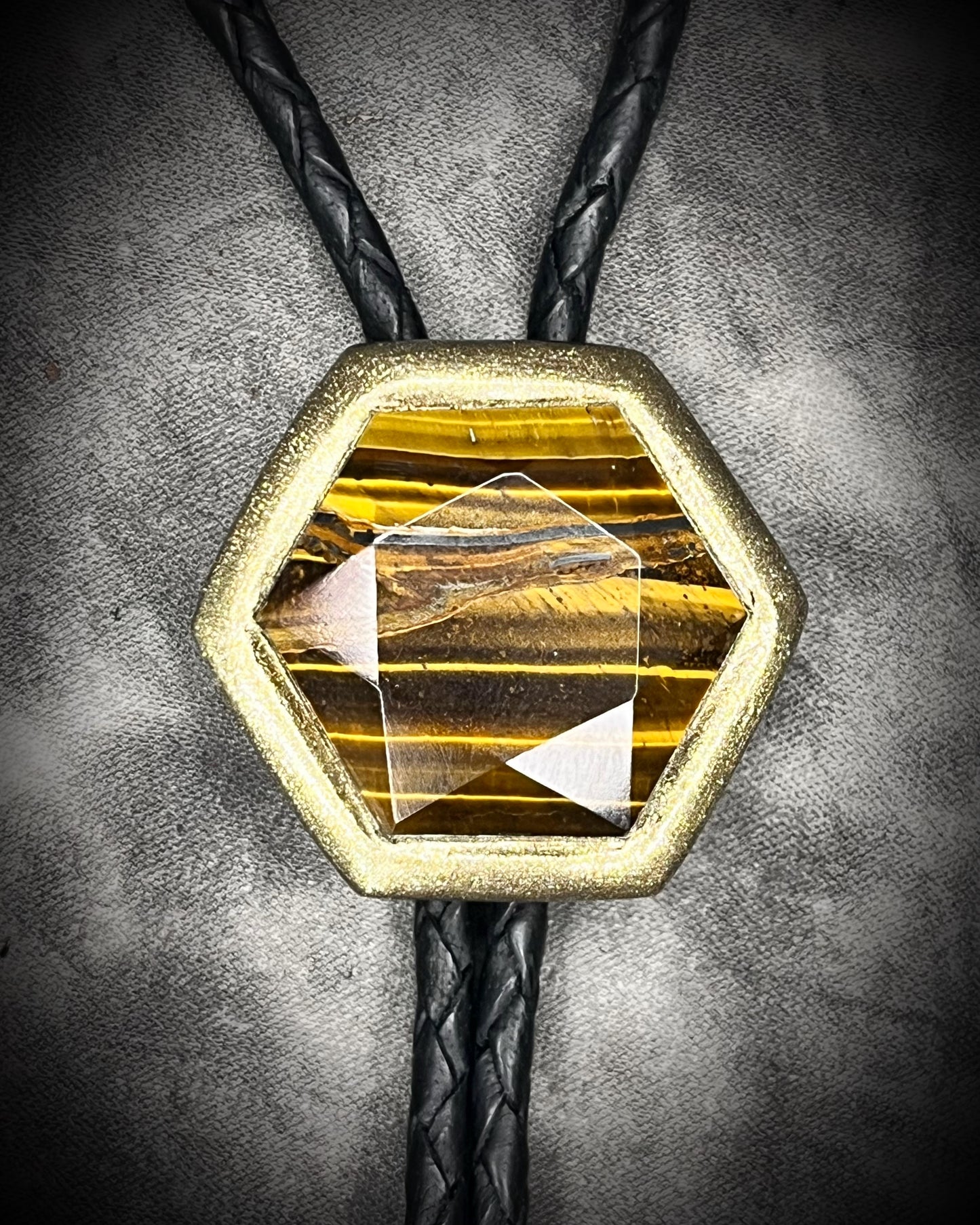 Tiger’s Eye hexagon bolo tie on black leather – statement men’s bolo necklace, crystal bolo tie jewelry, mystical Western bolo for festival fashion.