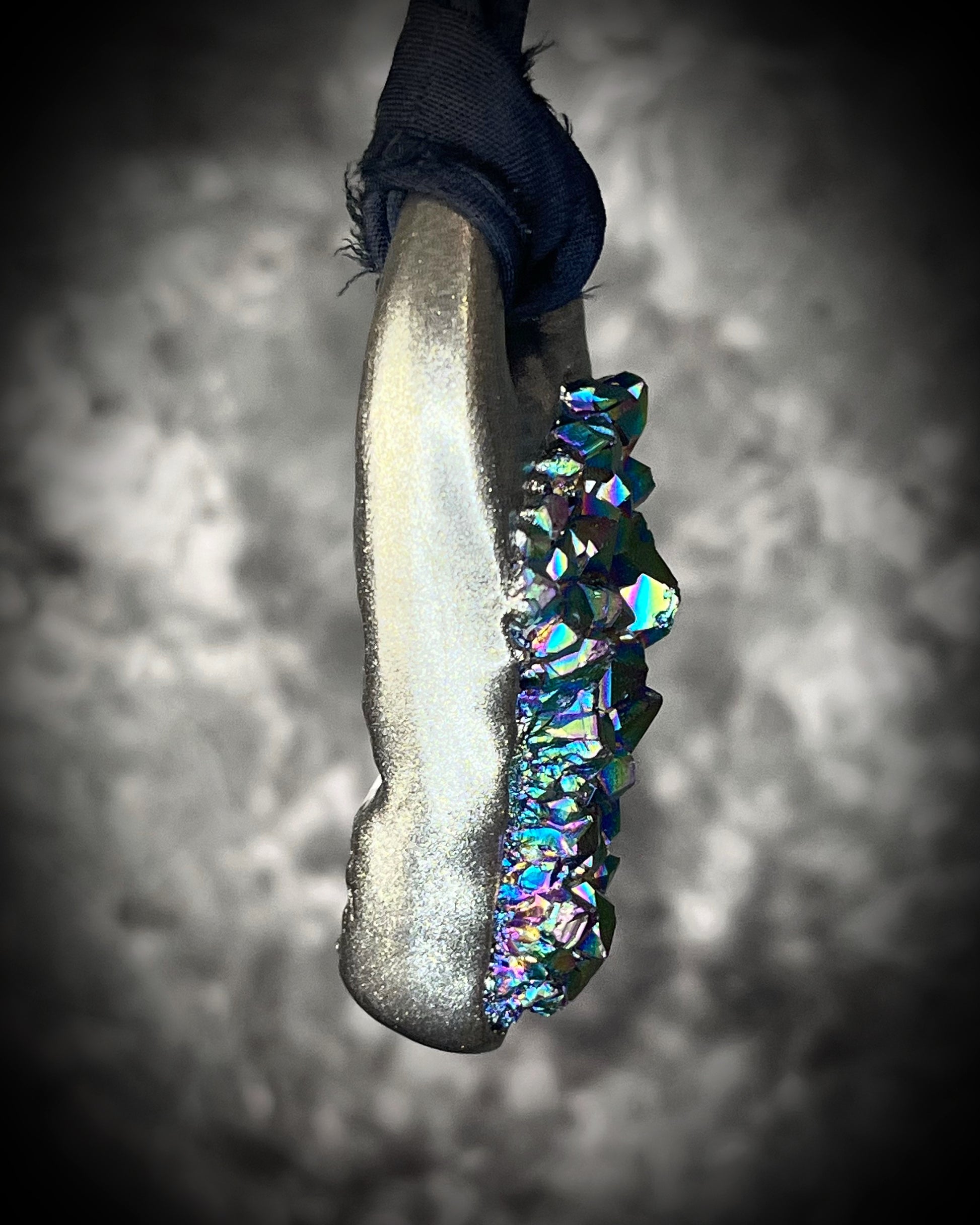 Side view o f titanium aura Amethyst pendant with iridescent gemstone druzy sparkle, handmade and hung from black recycled silk for an elegant holiday gift for her.