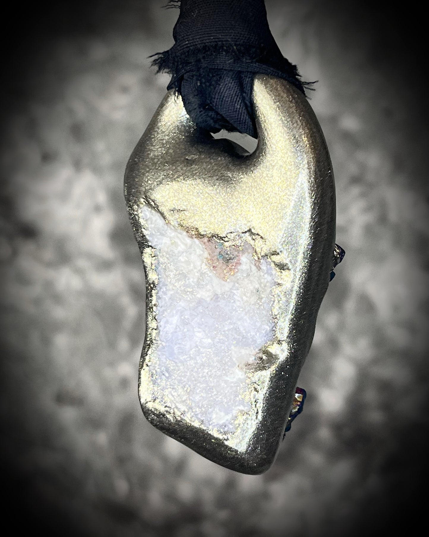 Back view of Titanium aura Amethyst pendant with iridescent gemstone druzy sparkle, handmade and hung from black recycled silk for an elegant holiday gift for her.