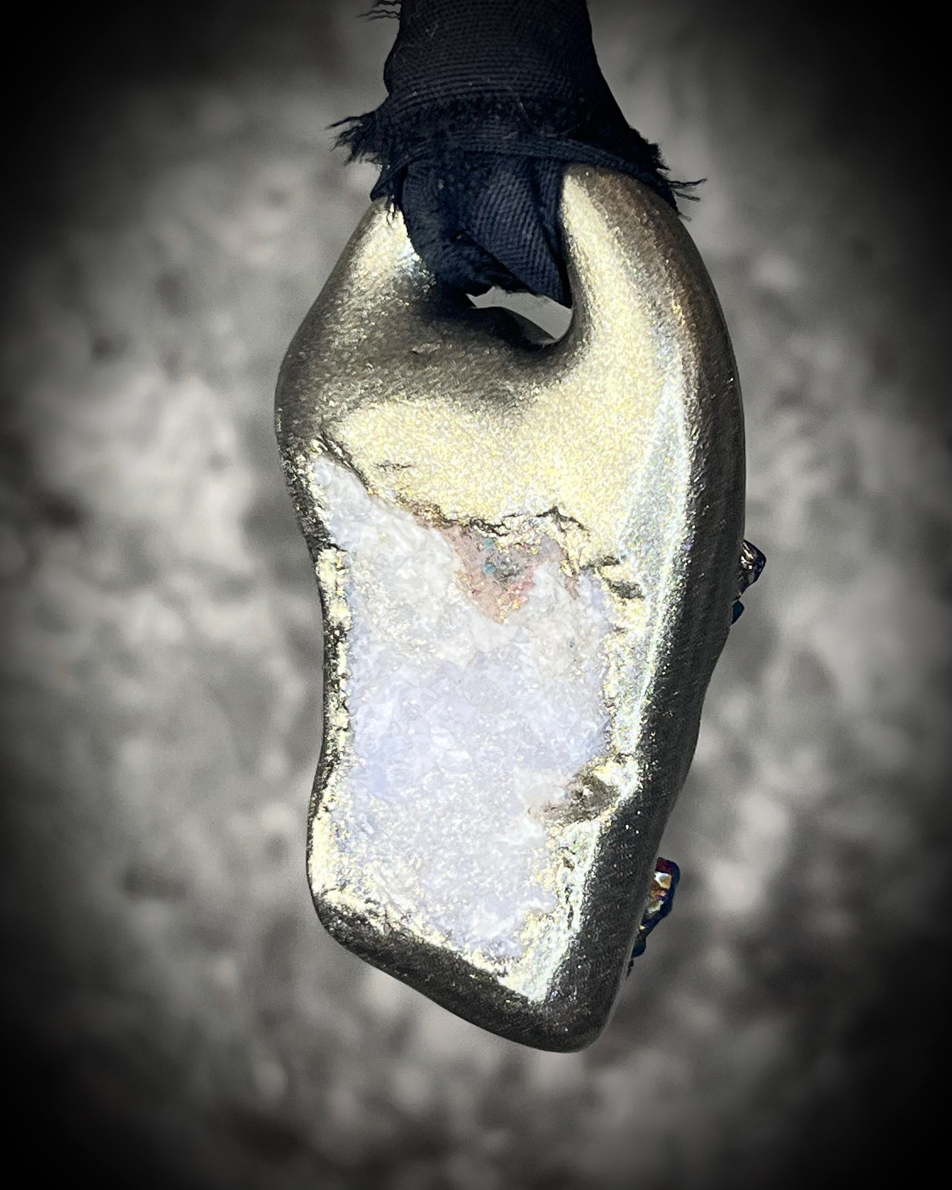 Back view of Titanium aura Amethyst pendant with iridescent gemstone druzy sparkle, handmade and hung from black recycled silk for an elegant holiday gift for her.