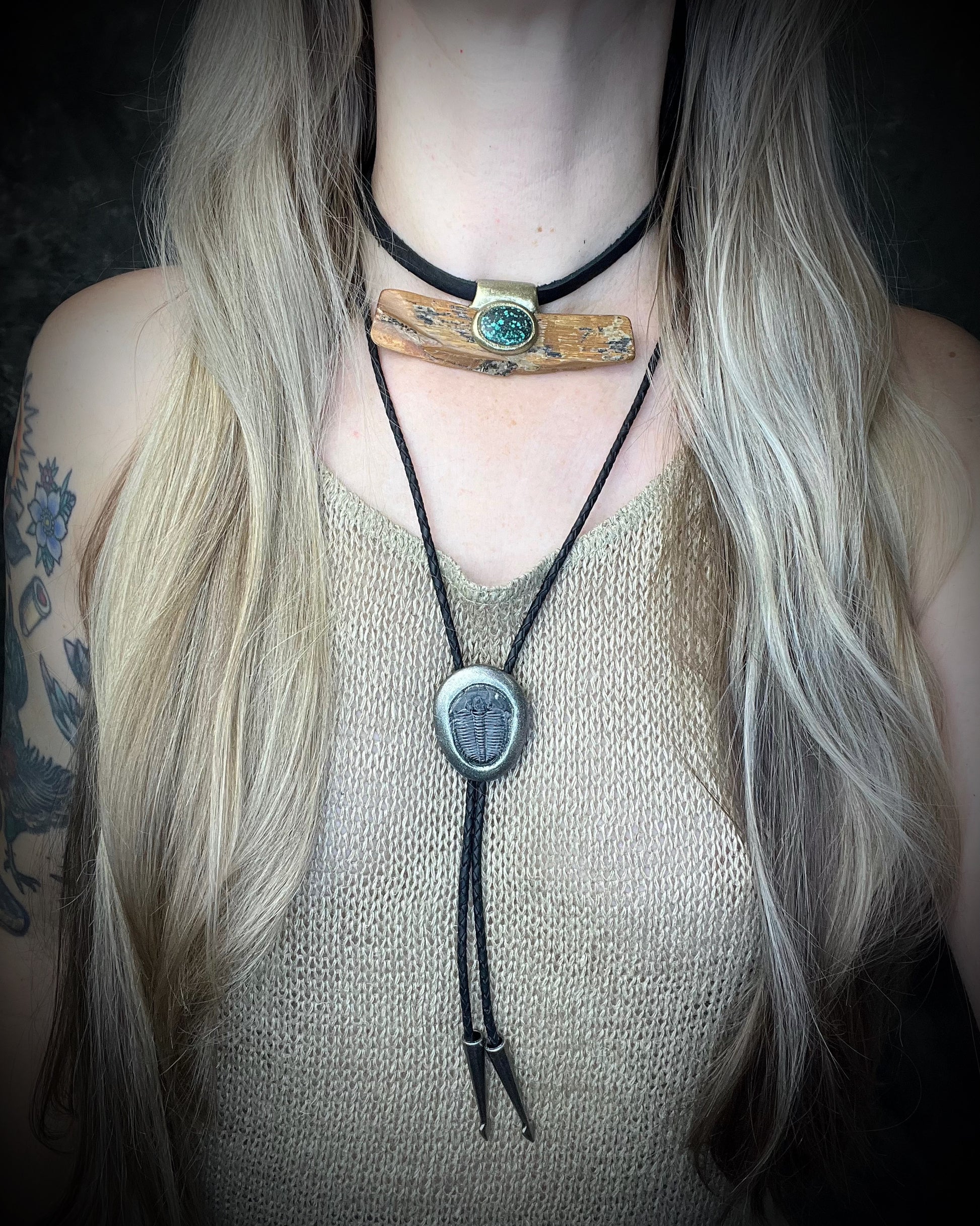 Trilobite fossil bolo tie with gunmetal finish, black leather, and dark silver bolo tips, handmade by Become Spellbound in Baltimore, Maryland.