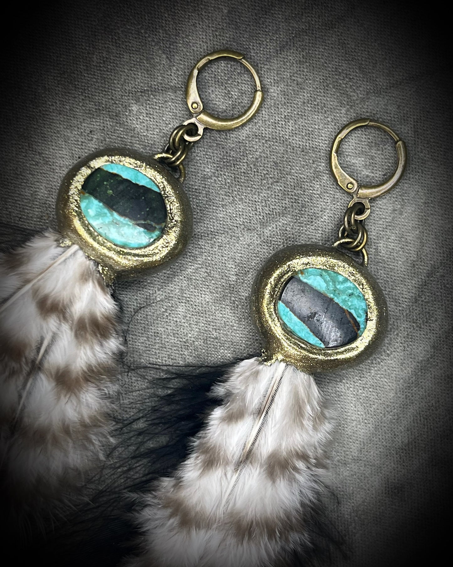 Turquoise and feather earrings with natural blue-green stone, gold finish, and hypoallergenic brass huggie hooks, handmade by Become Spellbound.