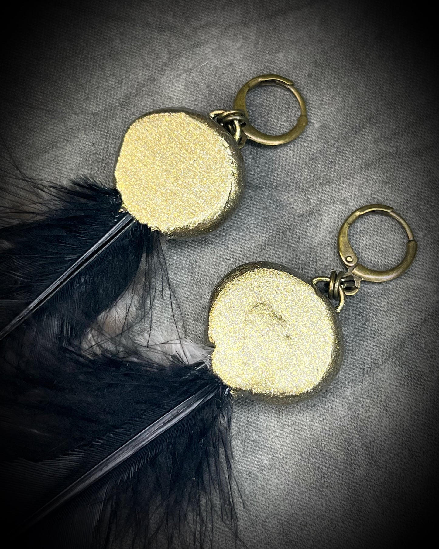 Turquoise and feather earrings with natural blue-green stone, gold finish, and hypoallergenic brass huggie hooks, handmade by Become Spellbound.