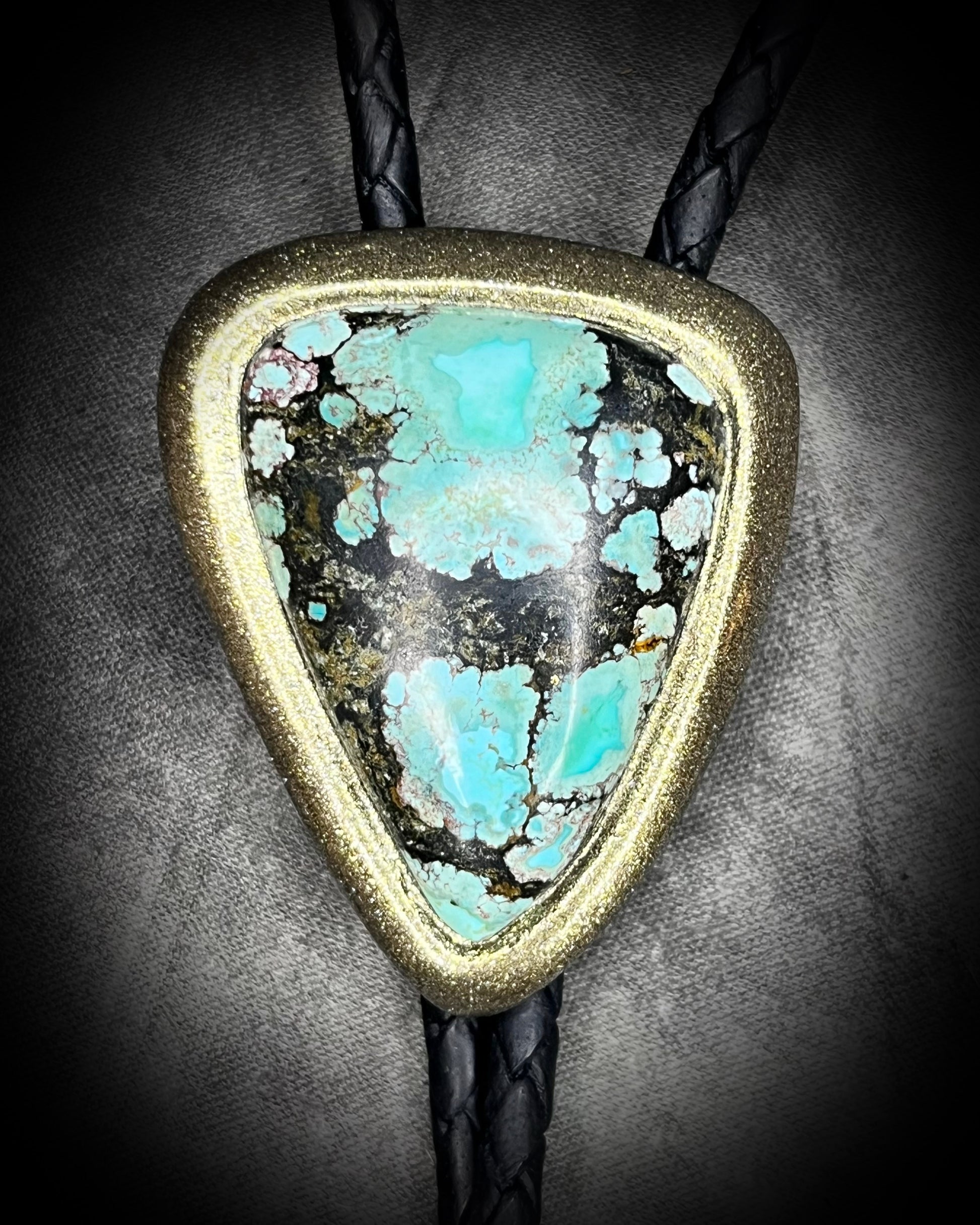Turquoise handmade bolo tie for him with gold finish on black leather. Boho western bolo tie necklace for spiritual rebels.