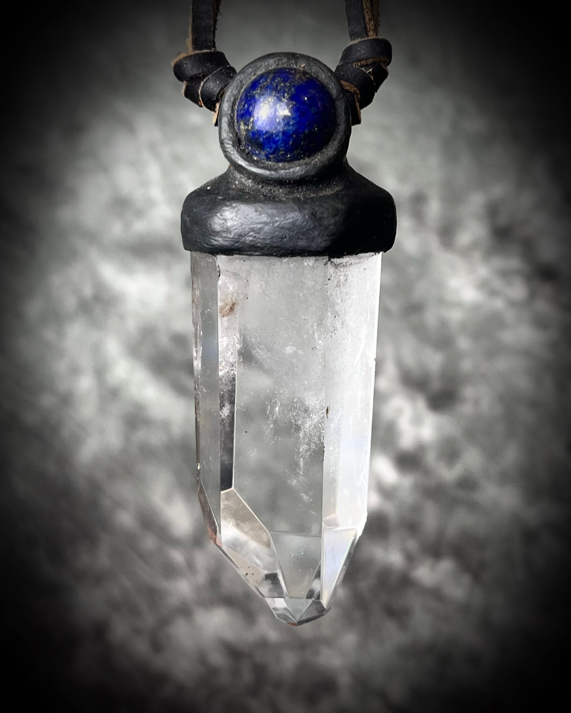 Unisex quartz point and lapis lazuli necklace on leather with a metal hook clasp, handmade in Thailand by artisan Anothai Hansen.