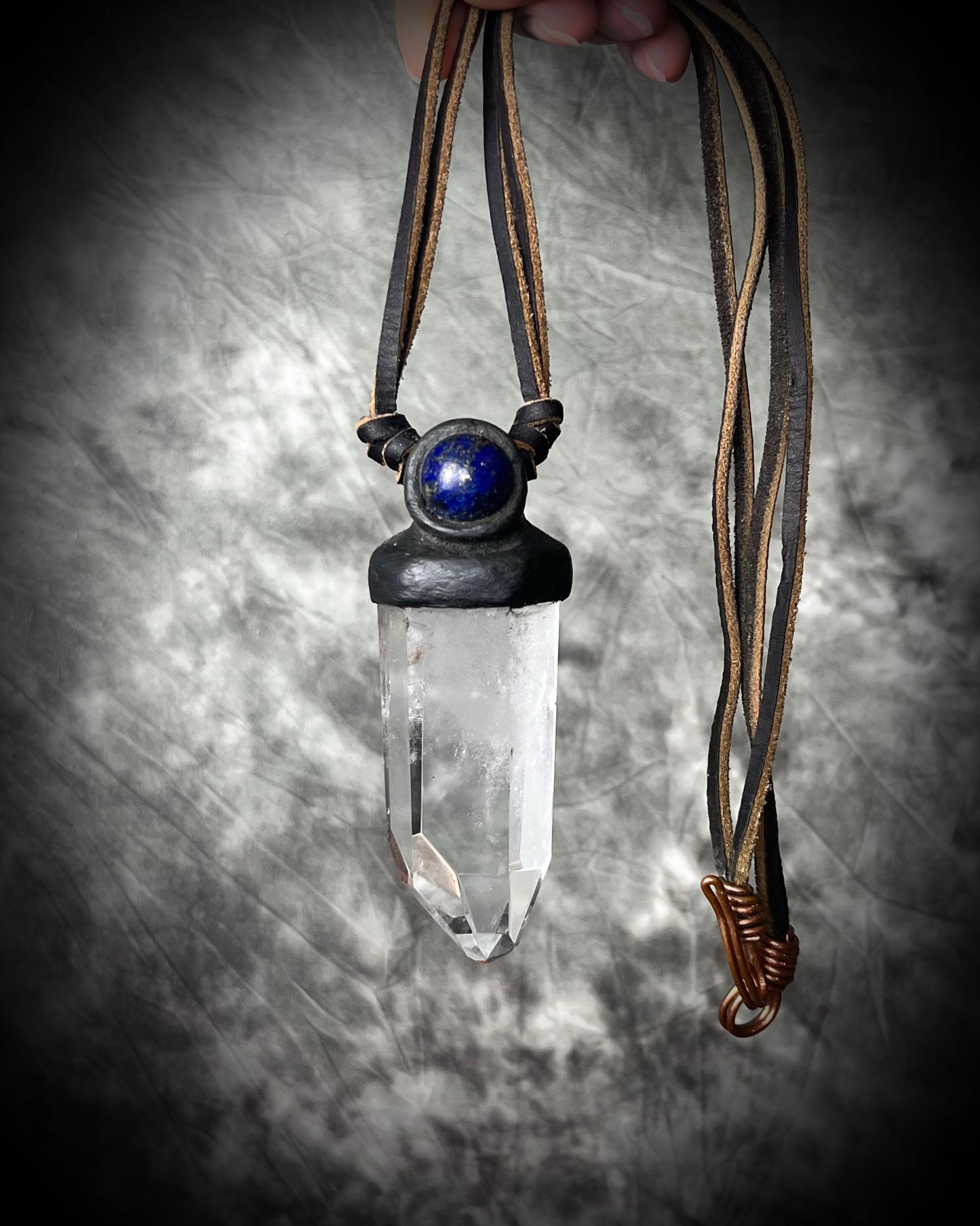 Unisex quartz point and lapis lazuli necklace on leather with a metal hook clasp, handmade in Thailand by artisan Anothai Hansen.