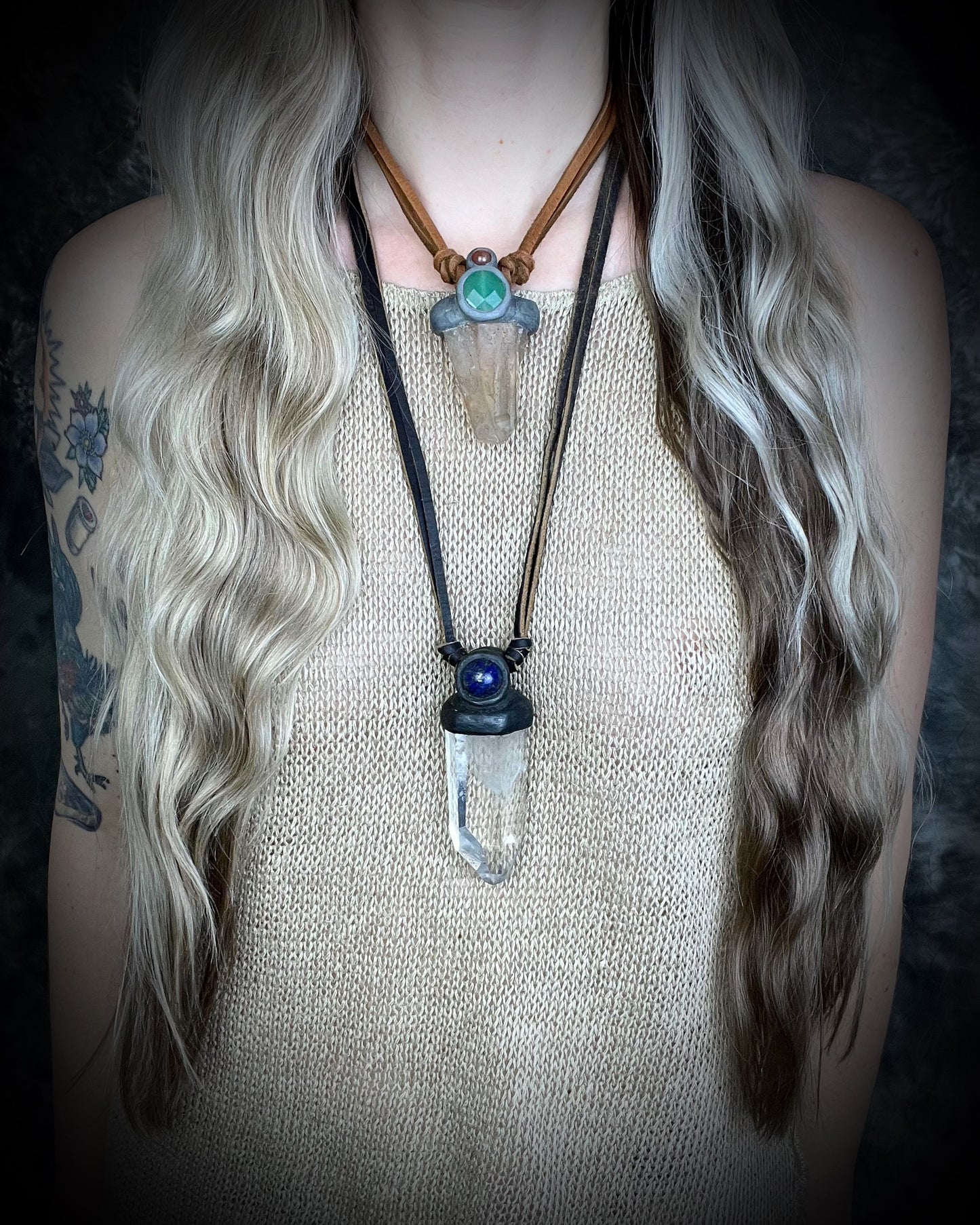 Model wearing layering necklaces including Unisex quartz point and lapis lazuli necklace on leather with a metal hook clasp, handmade in Thailand by artisan Anothai Hansen.
