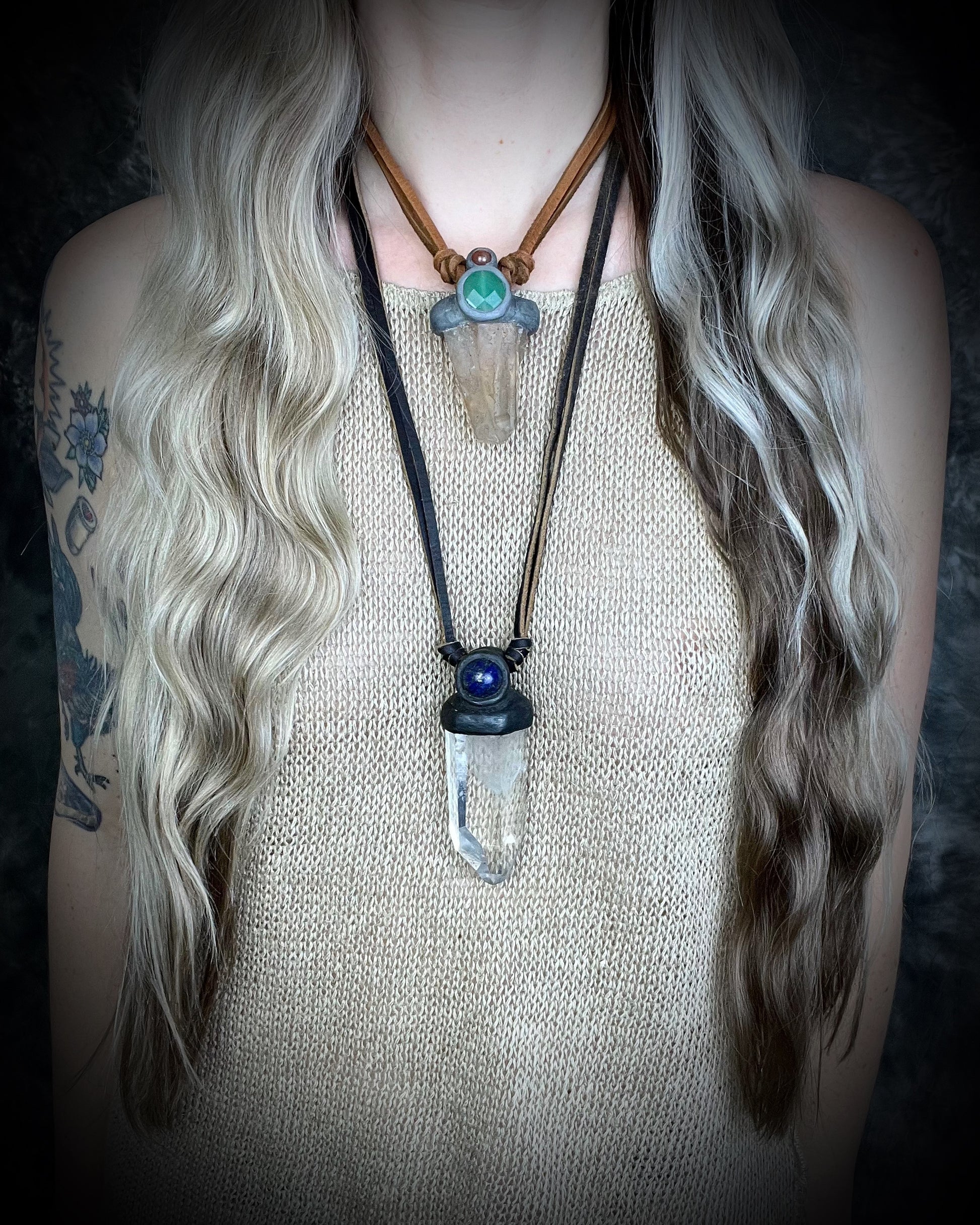Model wearing layering necklaces including Unisex quartz point and lapis lazuli necklace on leather with a metal hook clasp, handmade in Thailand by artisan Anothai Hansen.