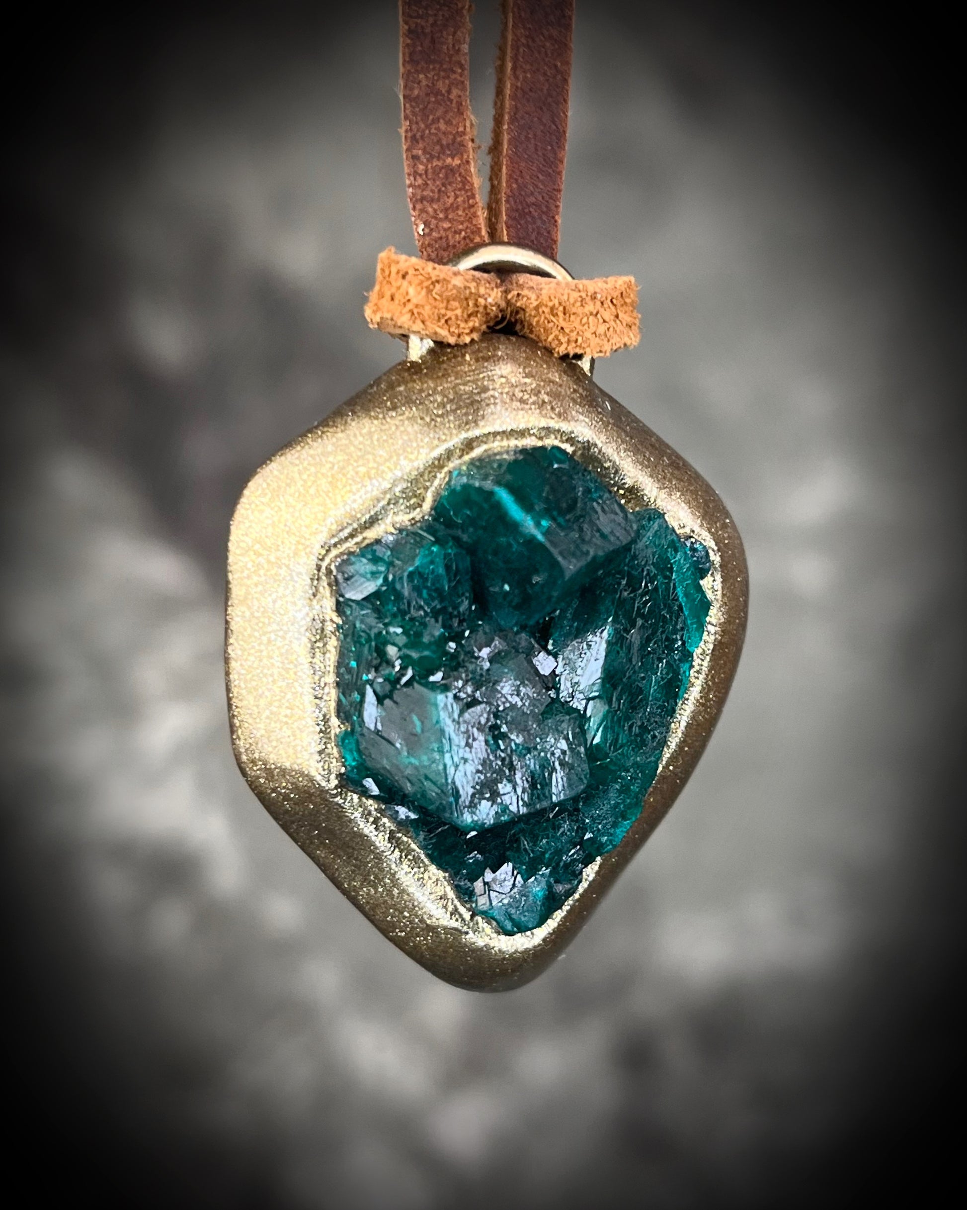 Vivid emerald green chunky dioptase crystal pendant handmade and set in a gold finish, hung from soft brown leather for an earthy, unisex vibe. Jewery for men or gift for her. Heart chakra jewelry.