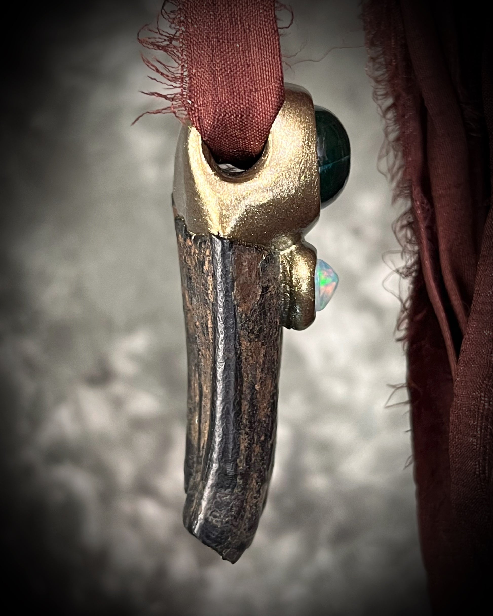 Western Style 'Year of the Horse 2026' inspired horse tooth fossil necklace with glowing green fluorite crystal and fiery opal gemstone. Gold finish horse necklace with brown recycled silk for an earthy and grounded talisman for her.