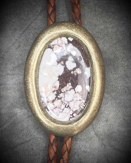 Wild Horse magnesite bolo tie with gold finish on brown leather cord, earthy Western statement jewelry featuring natural patterned stone, handmade bolo tie necklace Baltimore Maryland