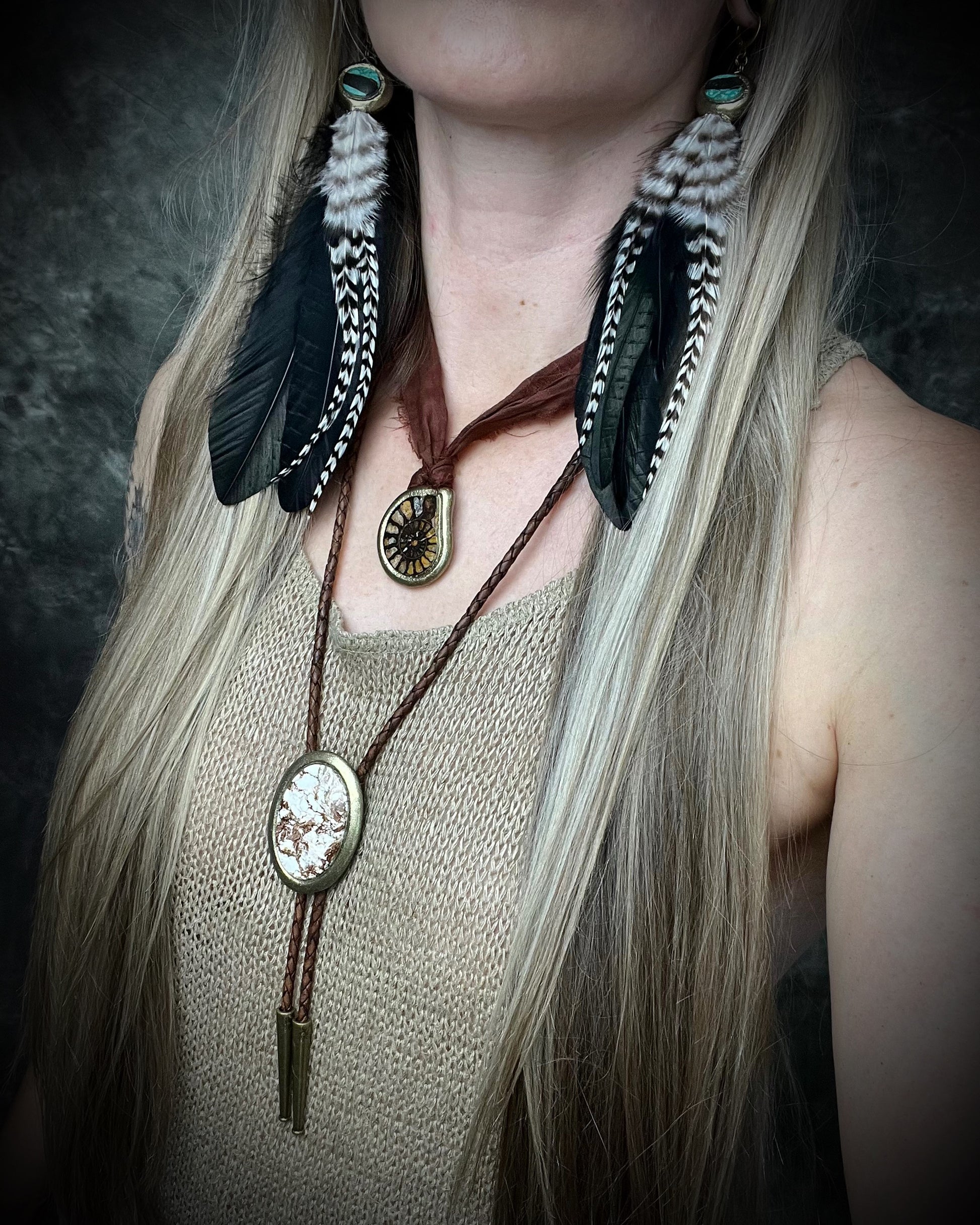 Wild Horse magnesite bolo tie with natural cream and brown markings, brown leather, gold finish, and gold bolo tips.