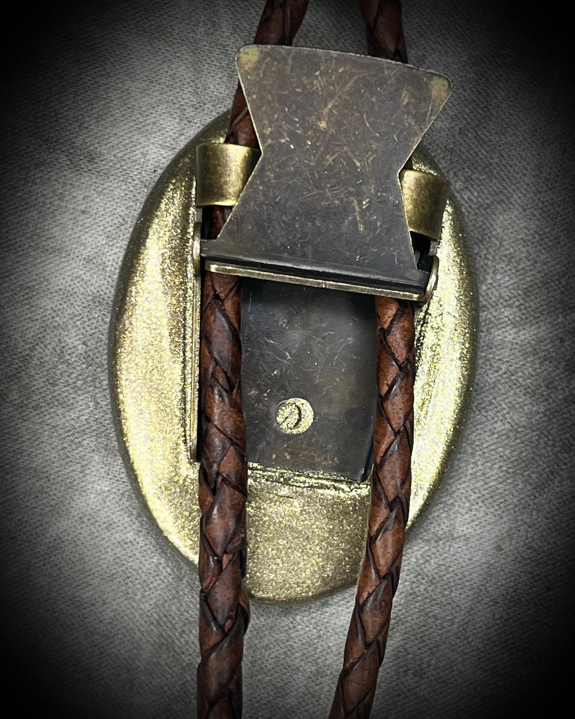 Wild Horse magnesite bolo tie with natural cream and brown markings, brown leather, gold finish, and gold bolo tips.