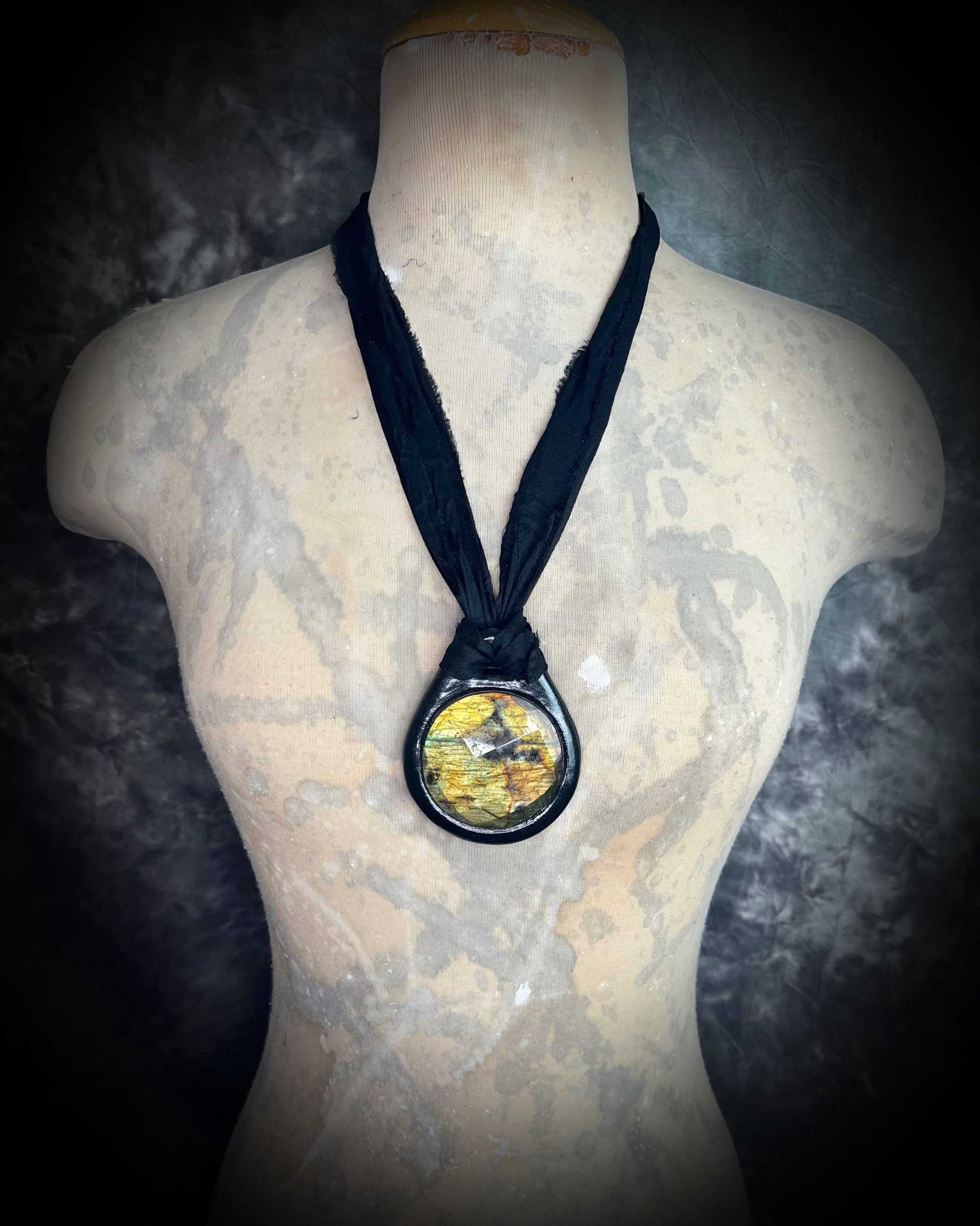 Witchy labradorite necklace on black recycled silk ribbon, hand-sculpted crystal talisman with iridescent gemstone pendant, boho gothic jewelry for modern witches.